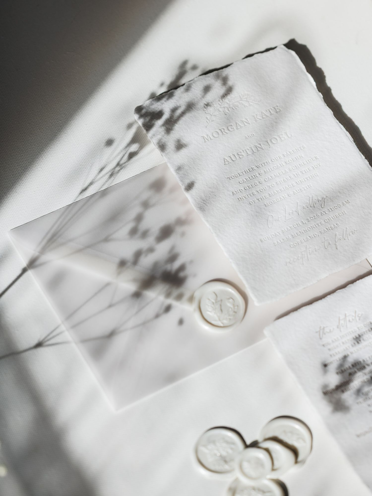 Close-up view of white marble textured business cards with minimalist gold foil details and elegant typography.