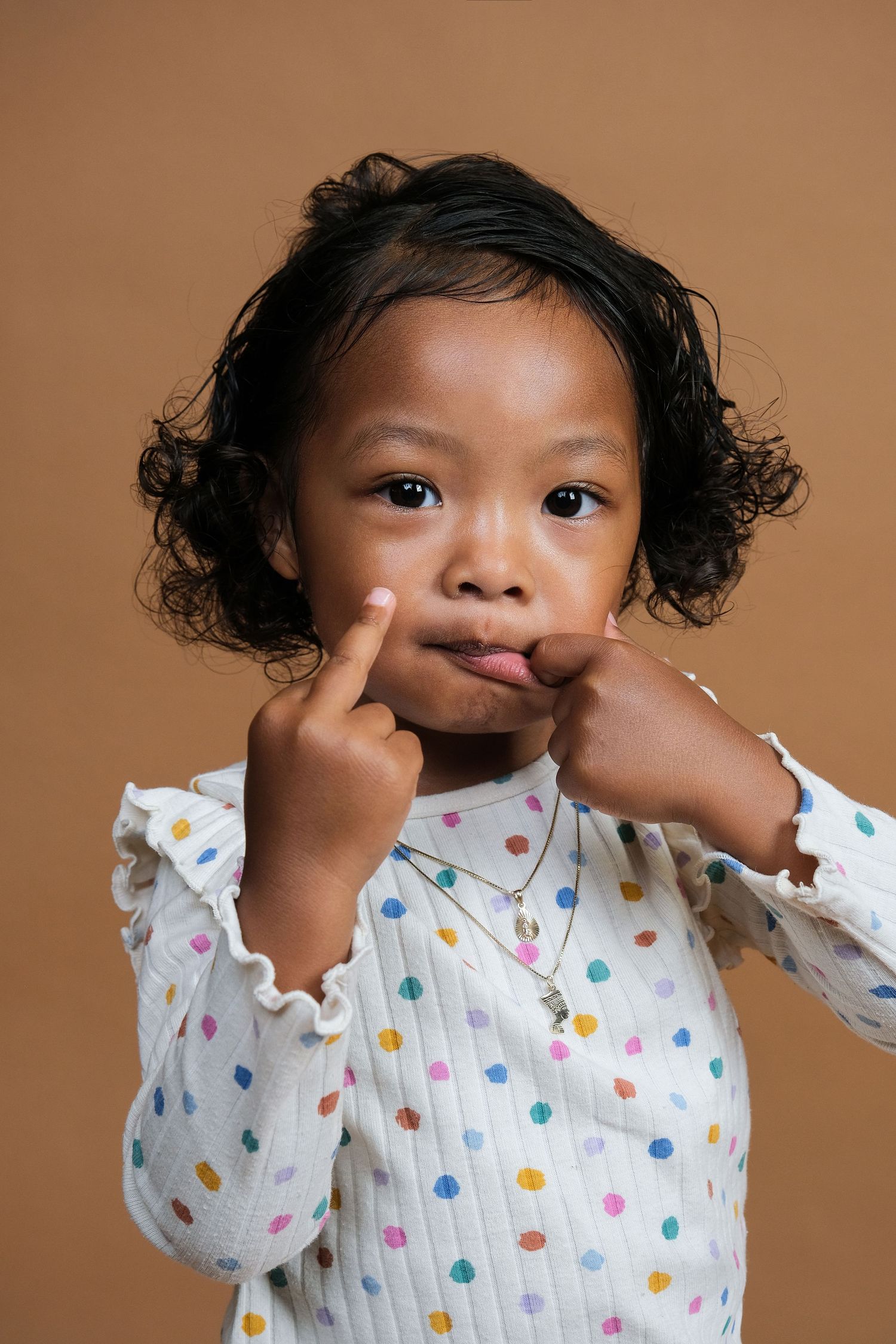 Toddler posing with their middle finger, shot with a Fujifilm xt4