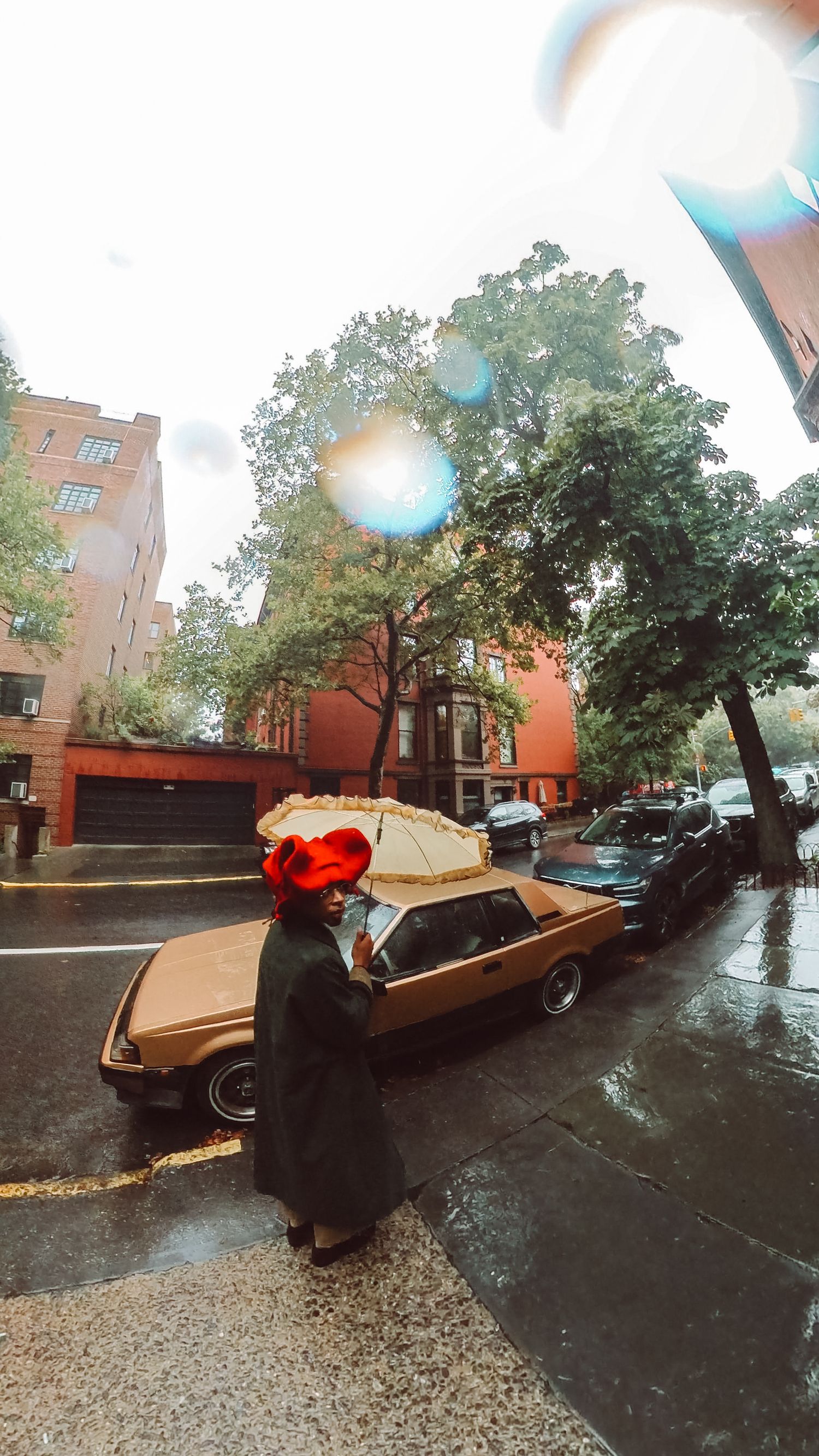 Artistic Brooklyn portrait of Ajai Kasim by the brownstone buildings, highlighting fashion and creativity.