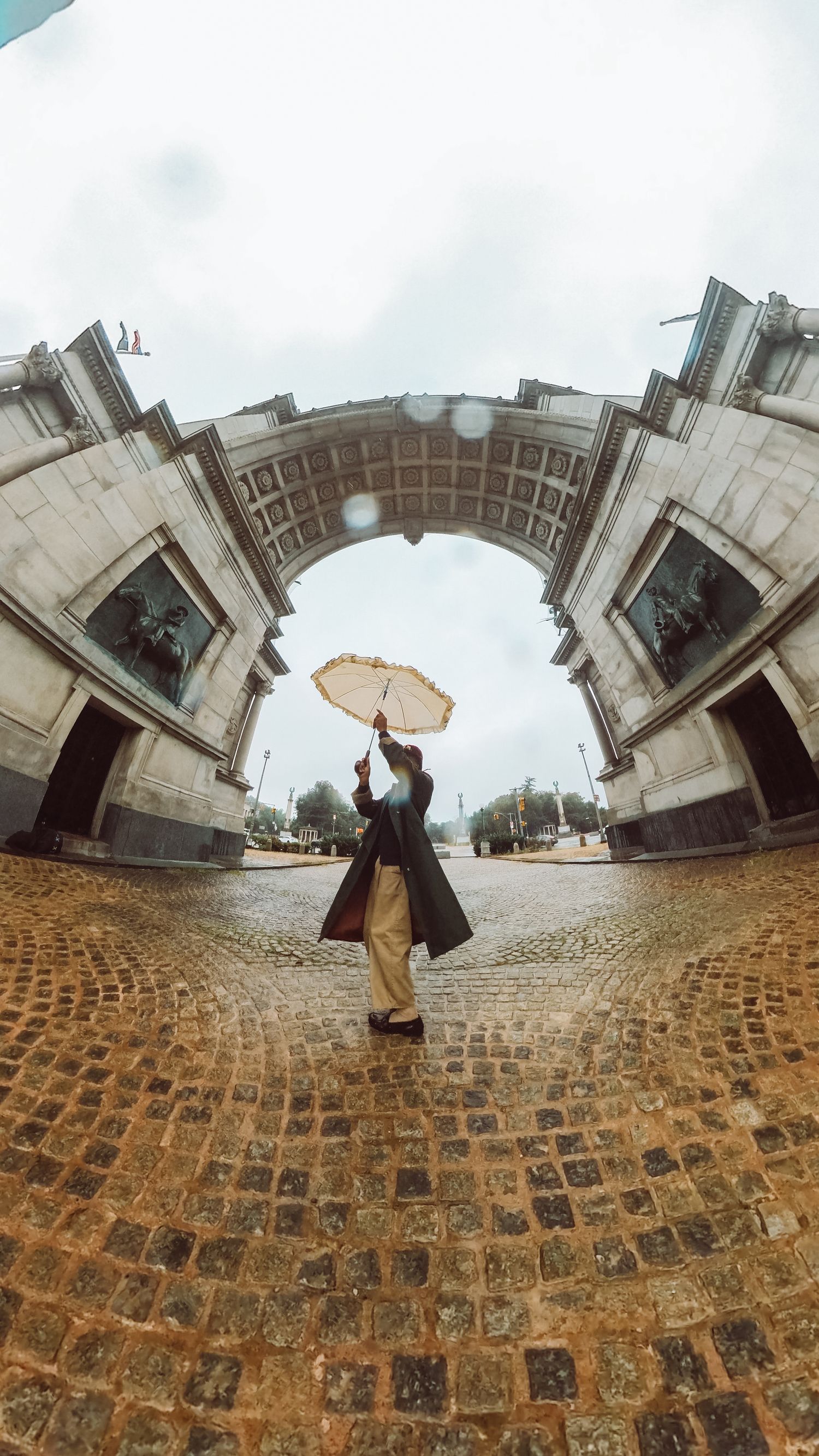 Artistic Brooklyn portrait of Ajai Kasim in front of Grand Army Plaza, highlighting fashion and creativity.
