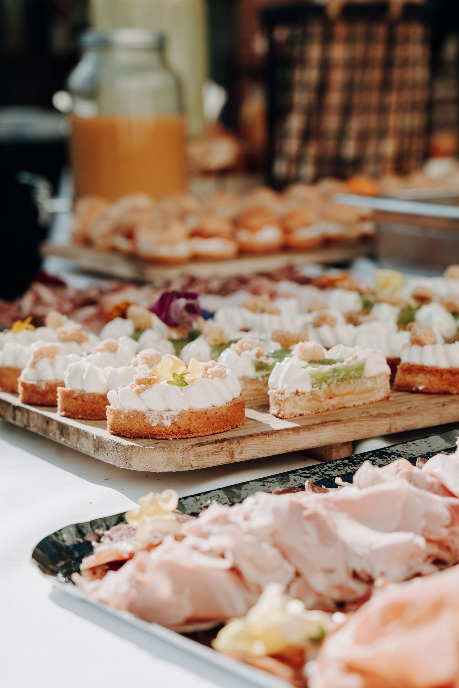 Elegant catering display of gourmet appetizers and finger foods on wooden serving boards.