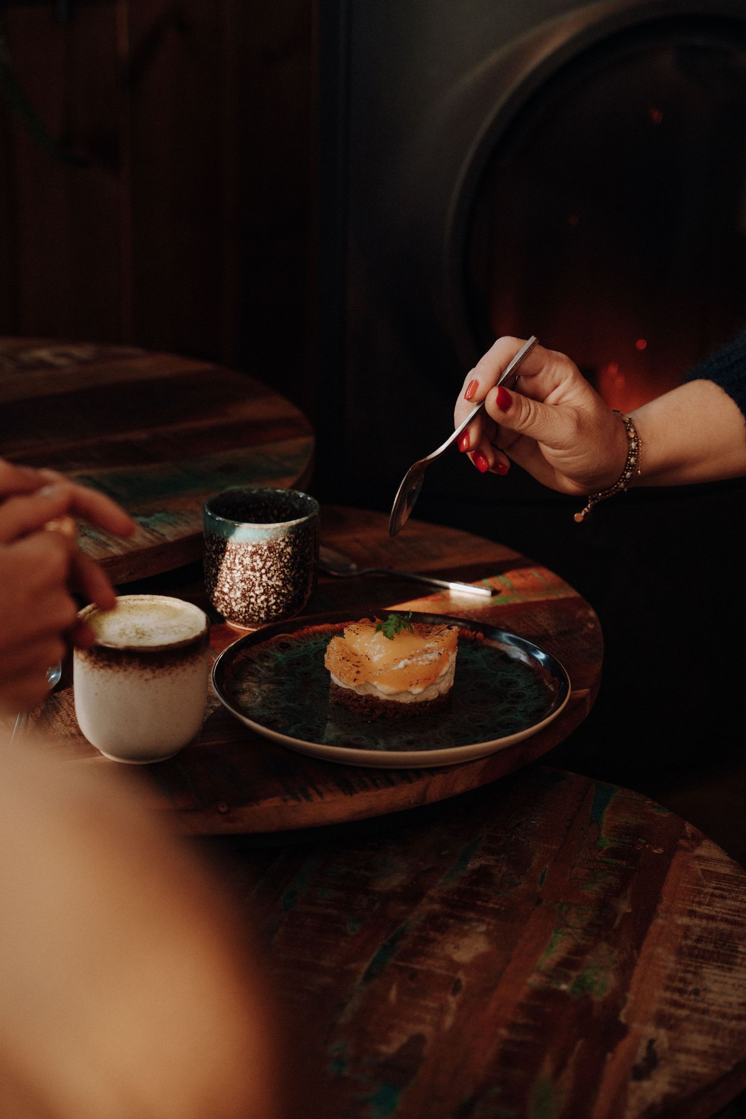 Dark and moody food photography sequence showing hands preparing breakfast with coffee and toast on rustic wooden table.
