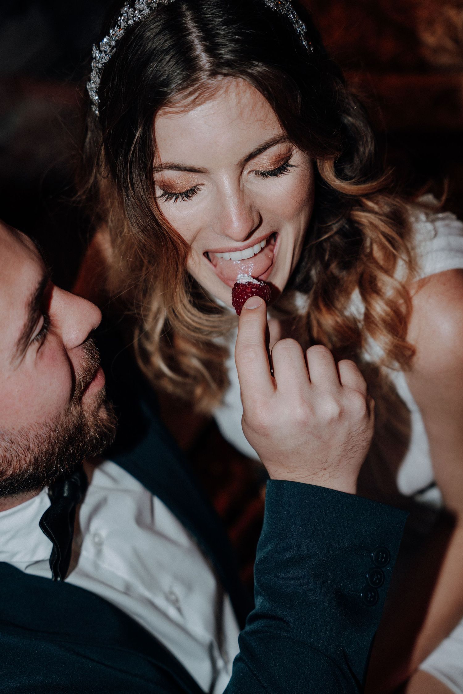Intimate close-up wedding portraits in dramatic moody lighting.