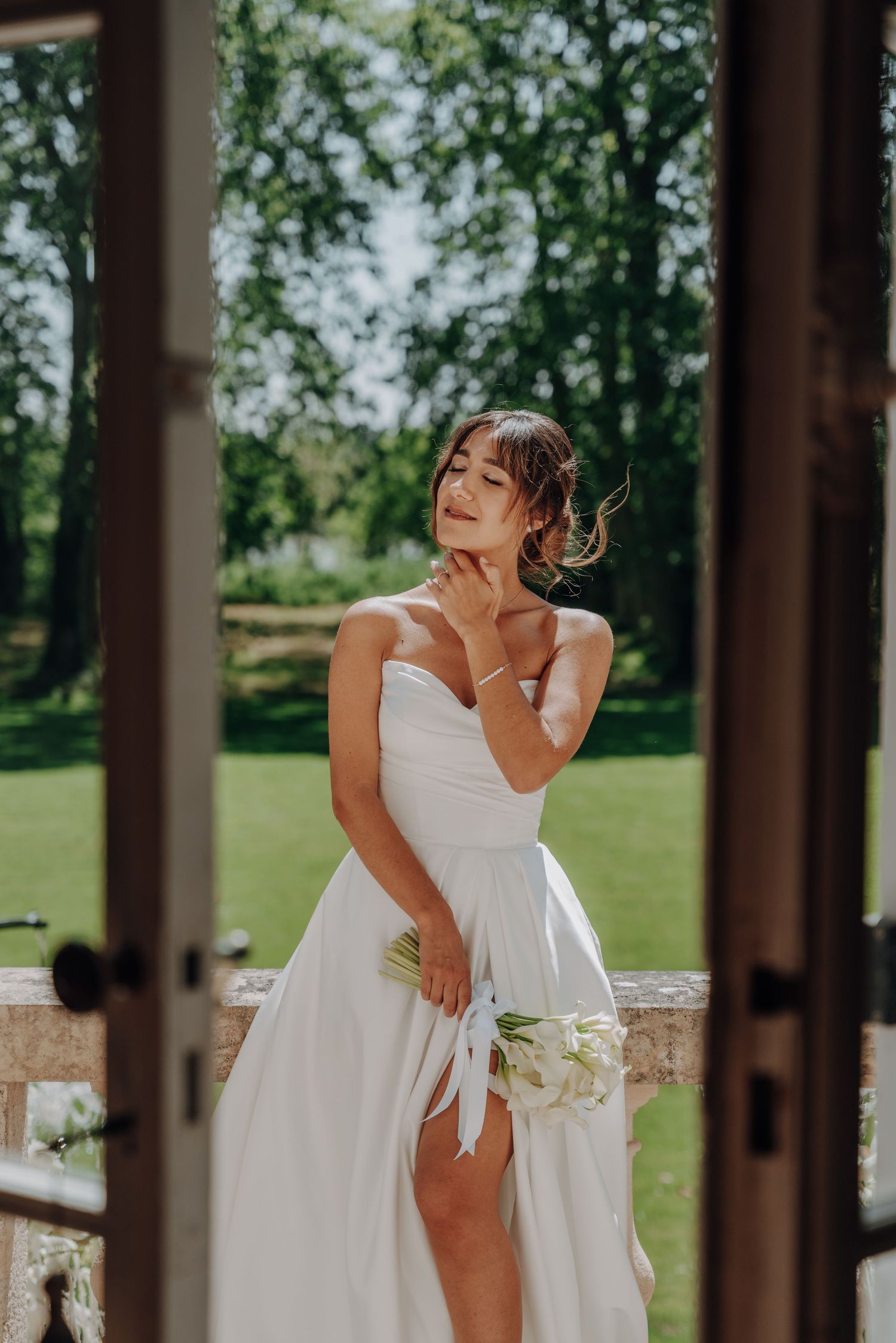 Candid moments of bride in white dress laughing on outdoor patio.