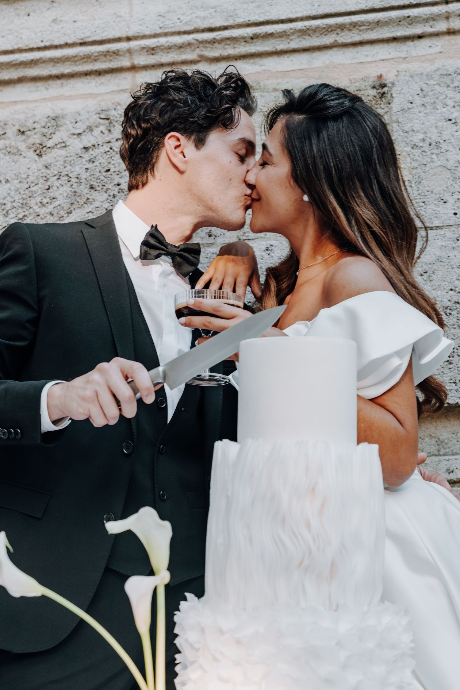 Black and white wedding cake cutting sequence with elegant styling.