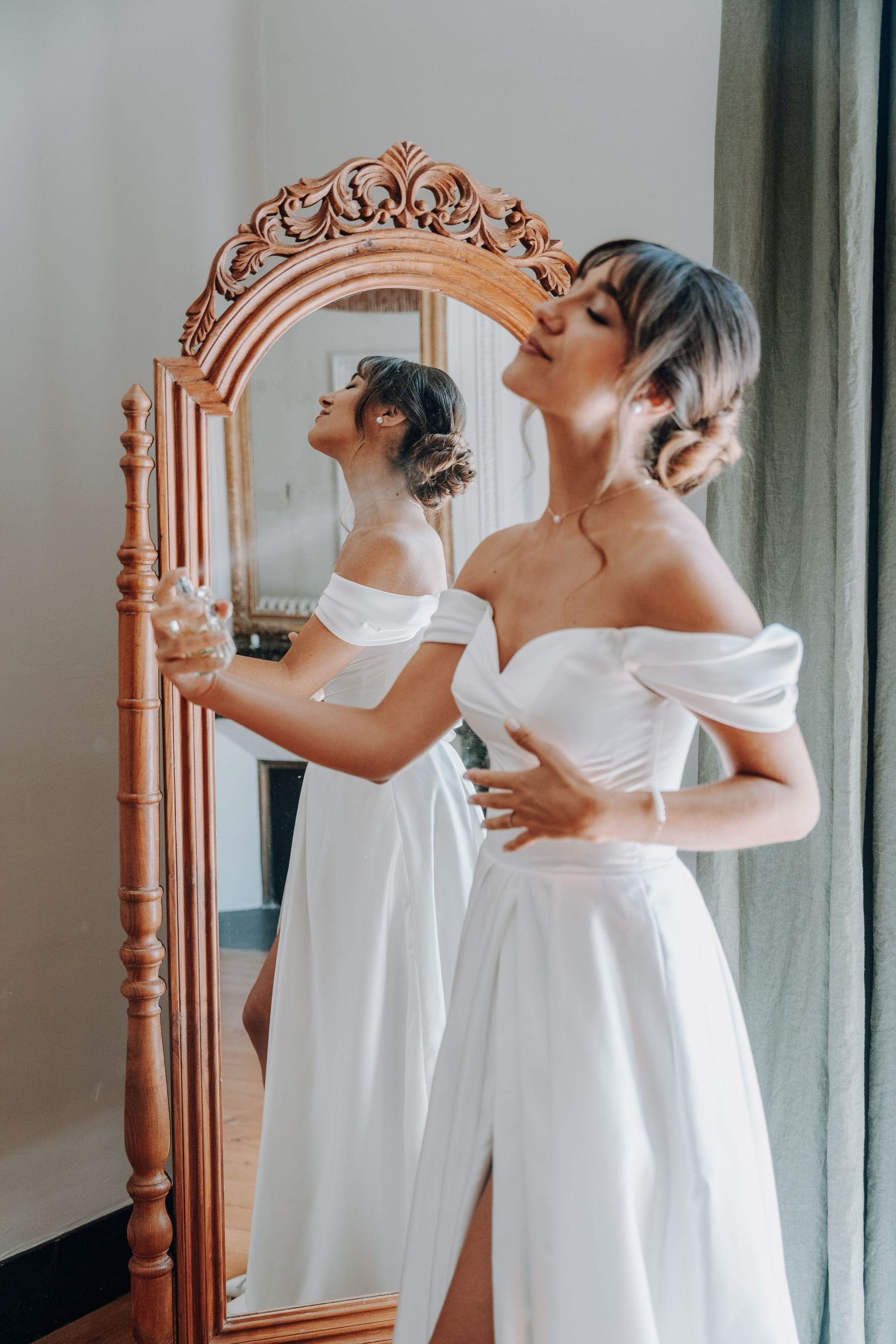 Elegant bridal portrait reflected in an ornate vintage mirror.
