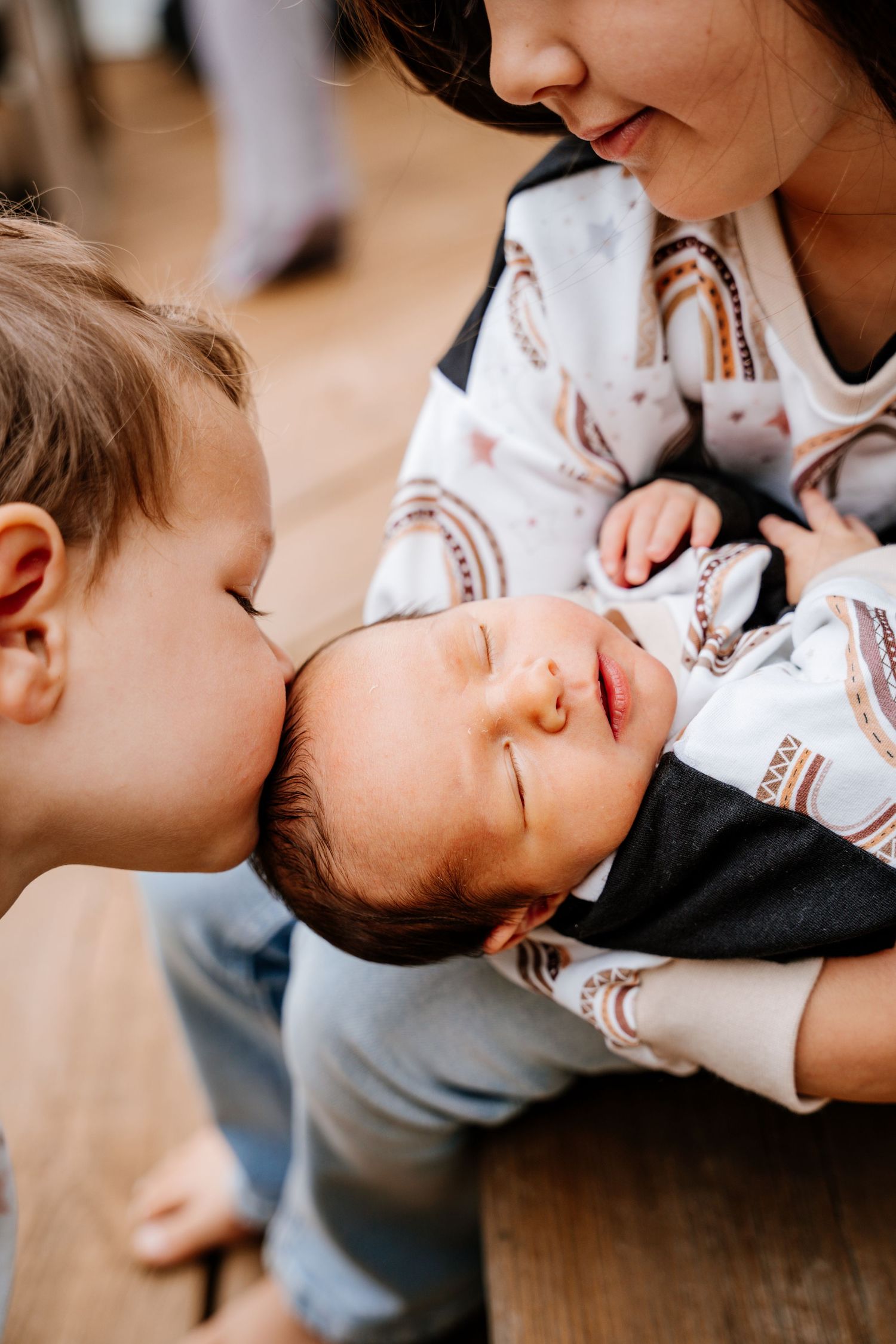 Two siblings share a tender moment of bonding and affection while playing together at home.