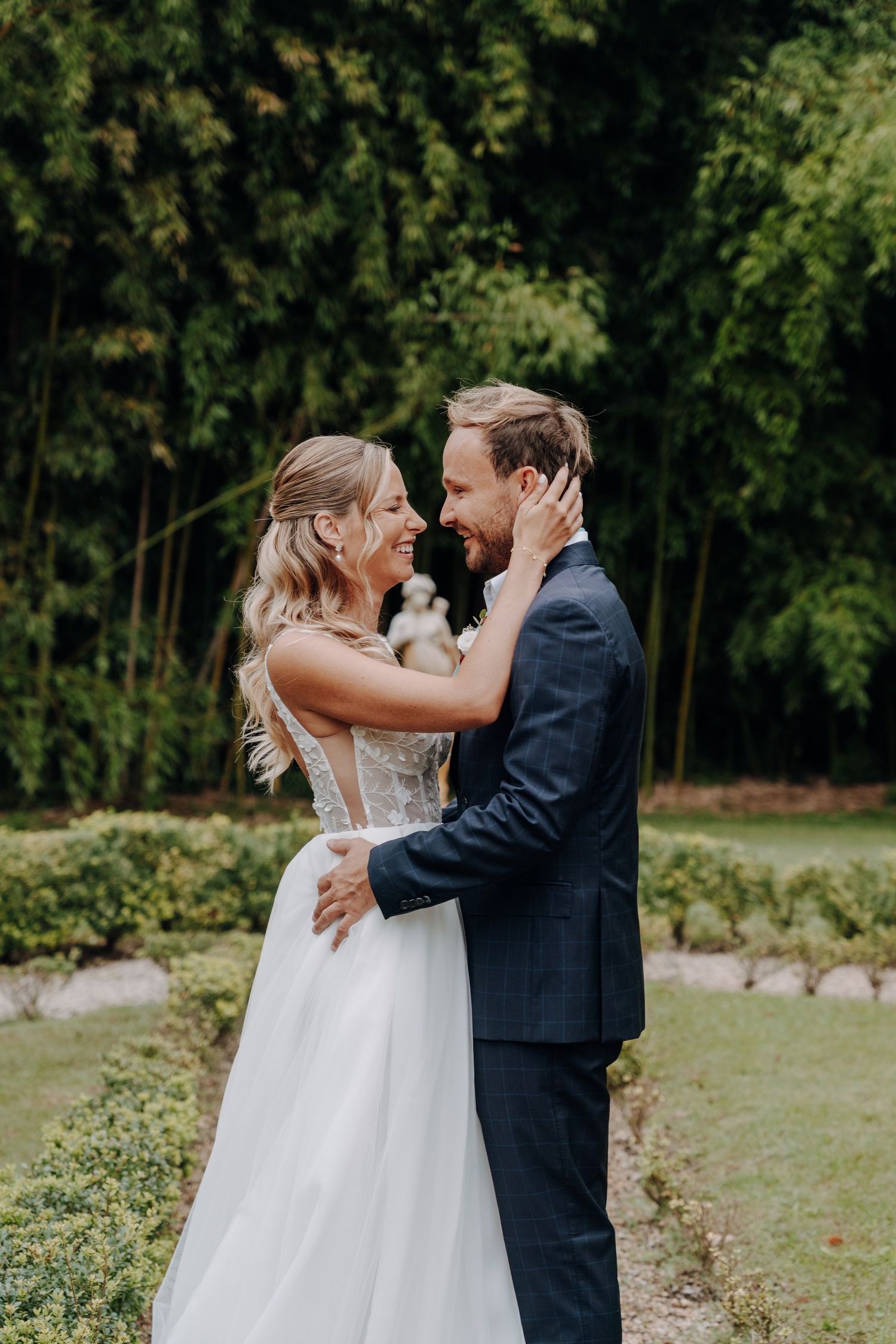 Romantic moment between newlyweds in a garden setting.
