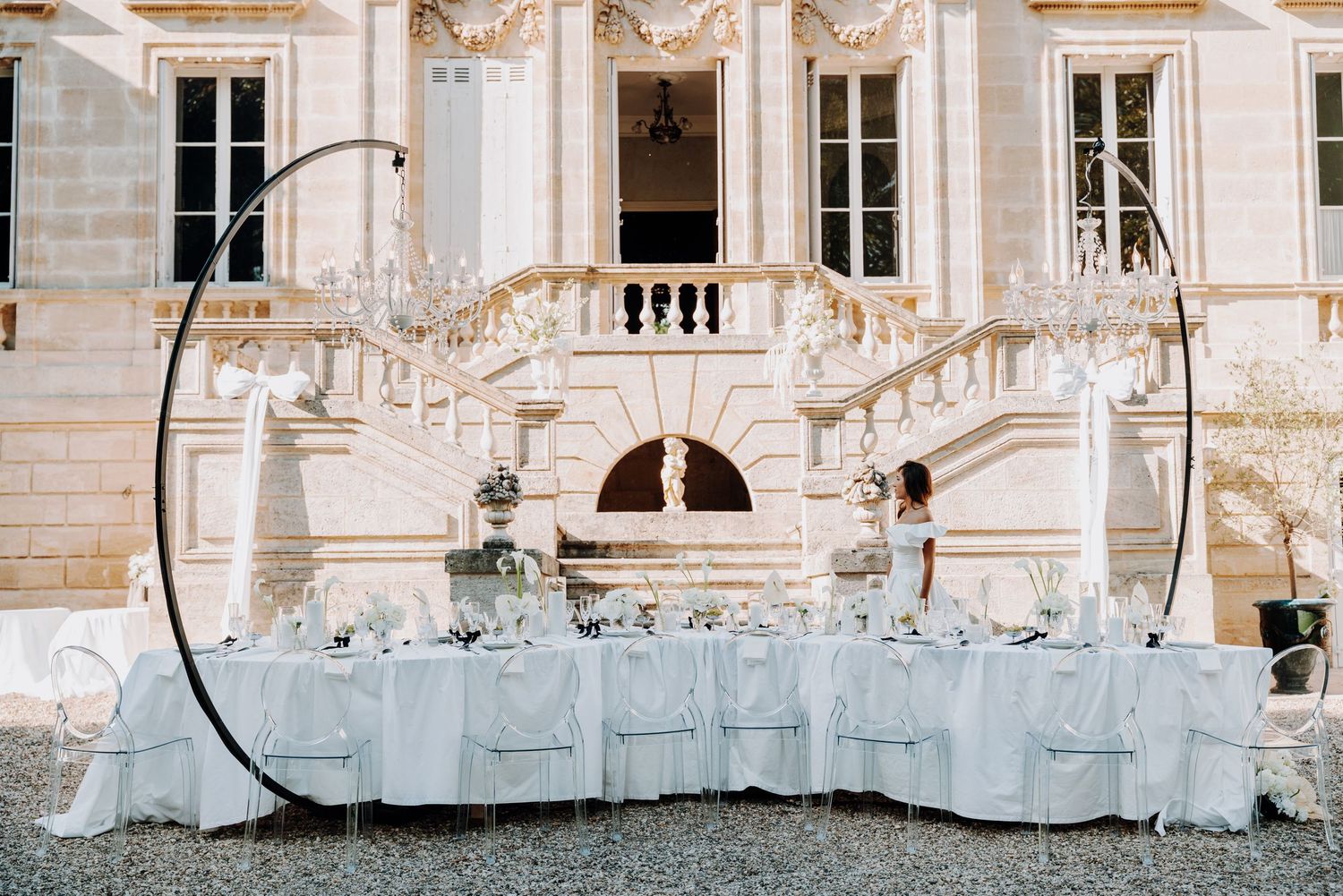 Elegant white stone mansion facade with ornate architectural details.