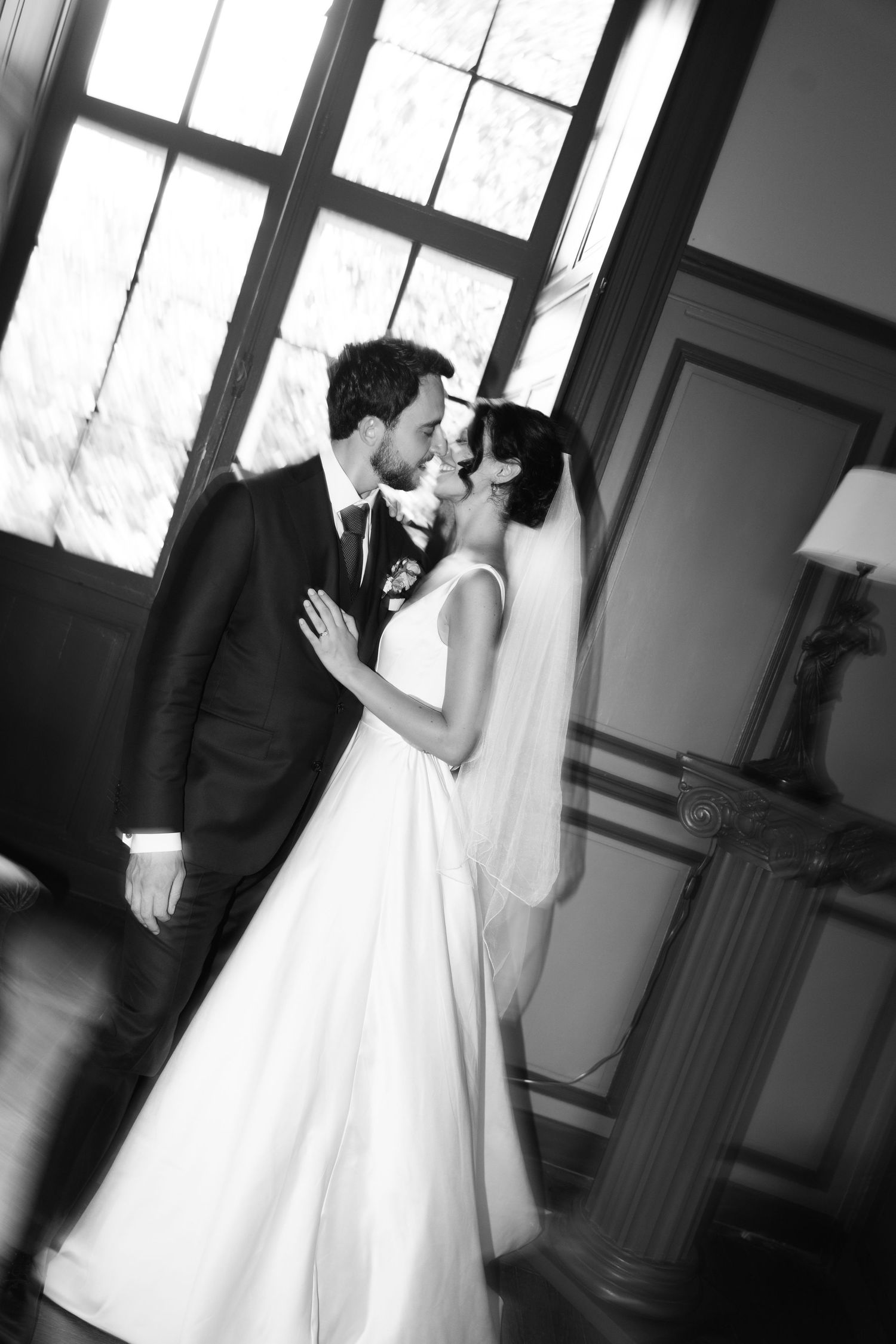 A romantic black and white wedding photo sequence showing a couple sharing their first kiss as newlyweds.