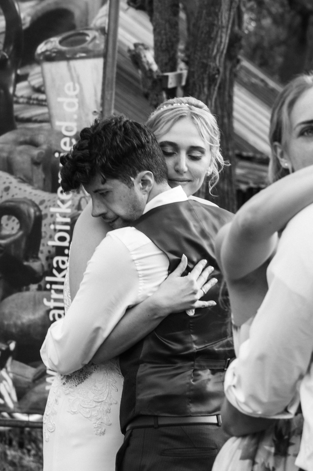 Emotional black and white photo of bride and groom sharing a heartfelt embrace at their wedding.