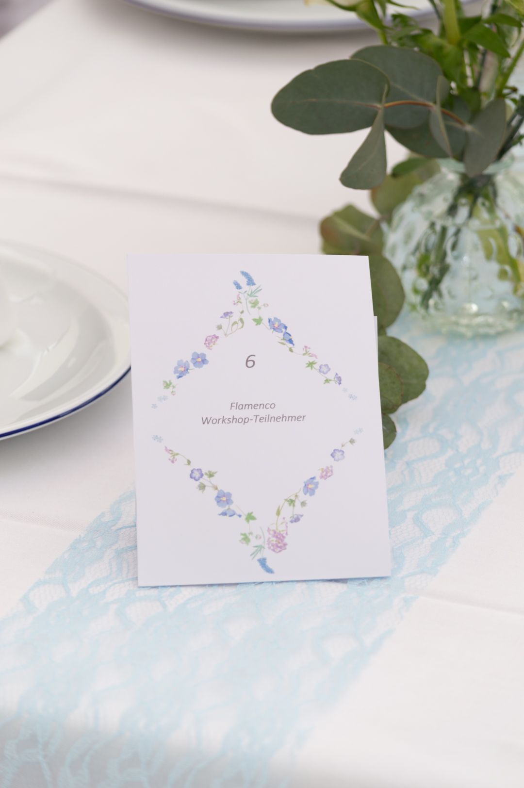 Elegant wedding table card number 6 for Flamenco Workshop guests, featuring delicate floral border design on white card.