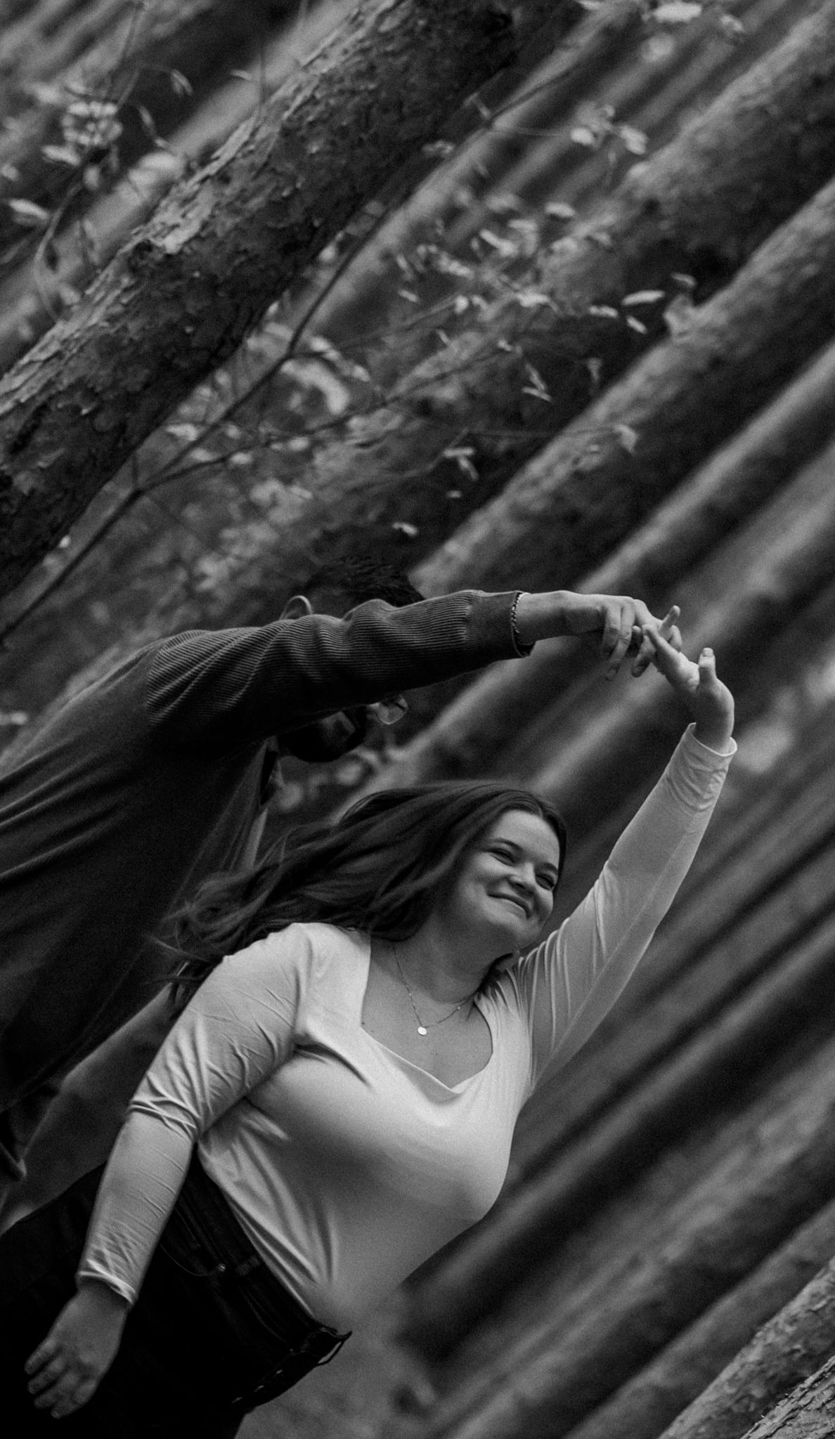 Black and white artistic portrait series in a forest setting.