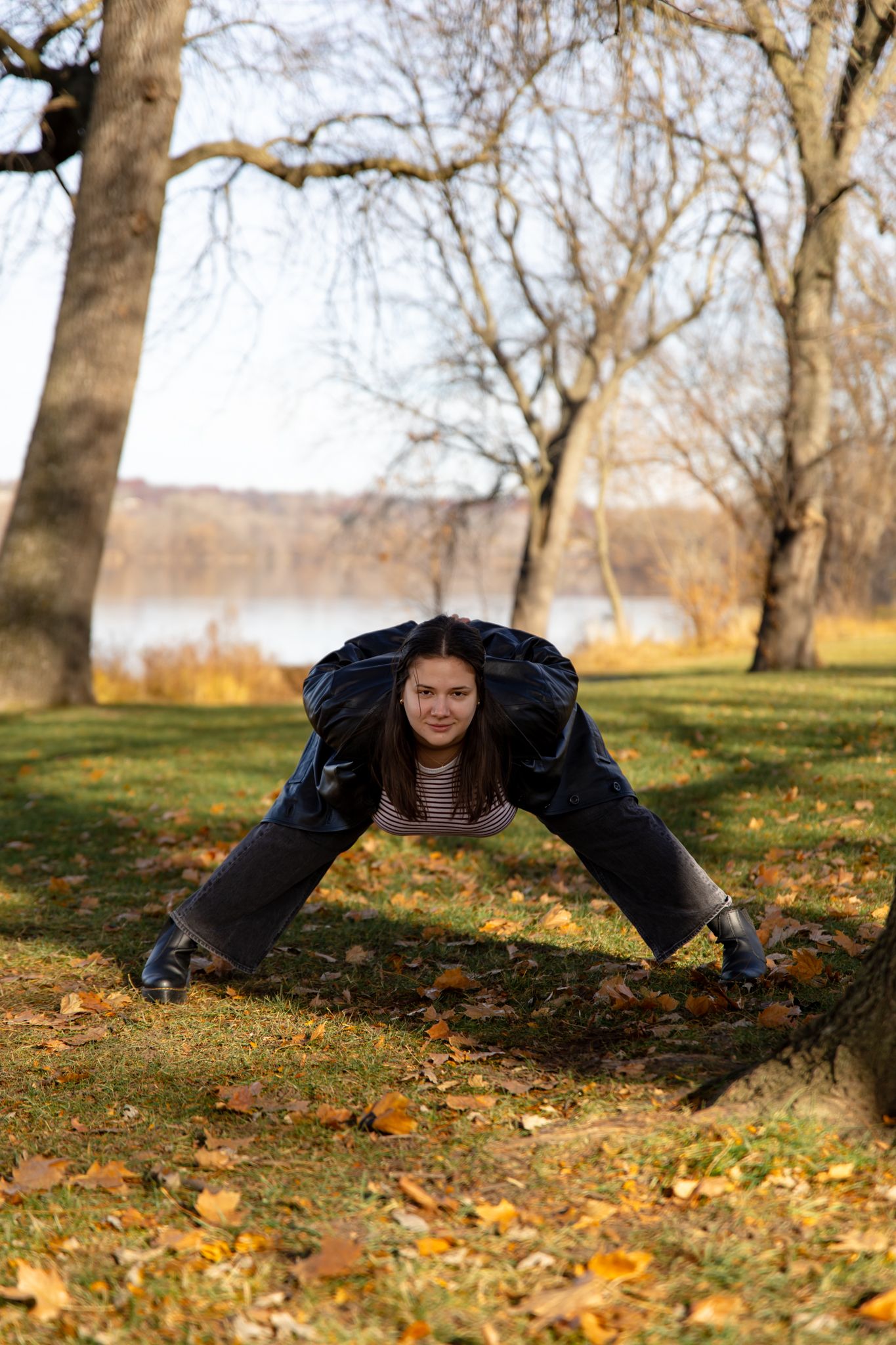 Dynamic poses captured on autumn grass showing acrobatic movements in black clothing.
