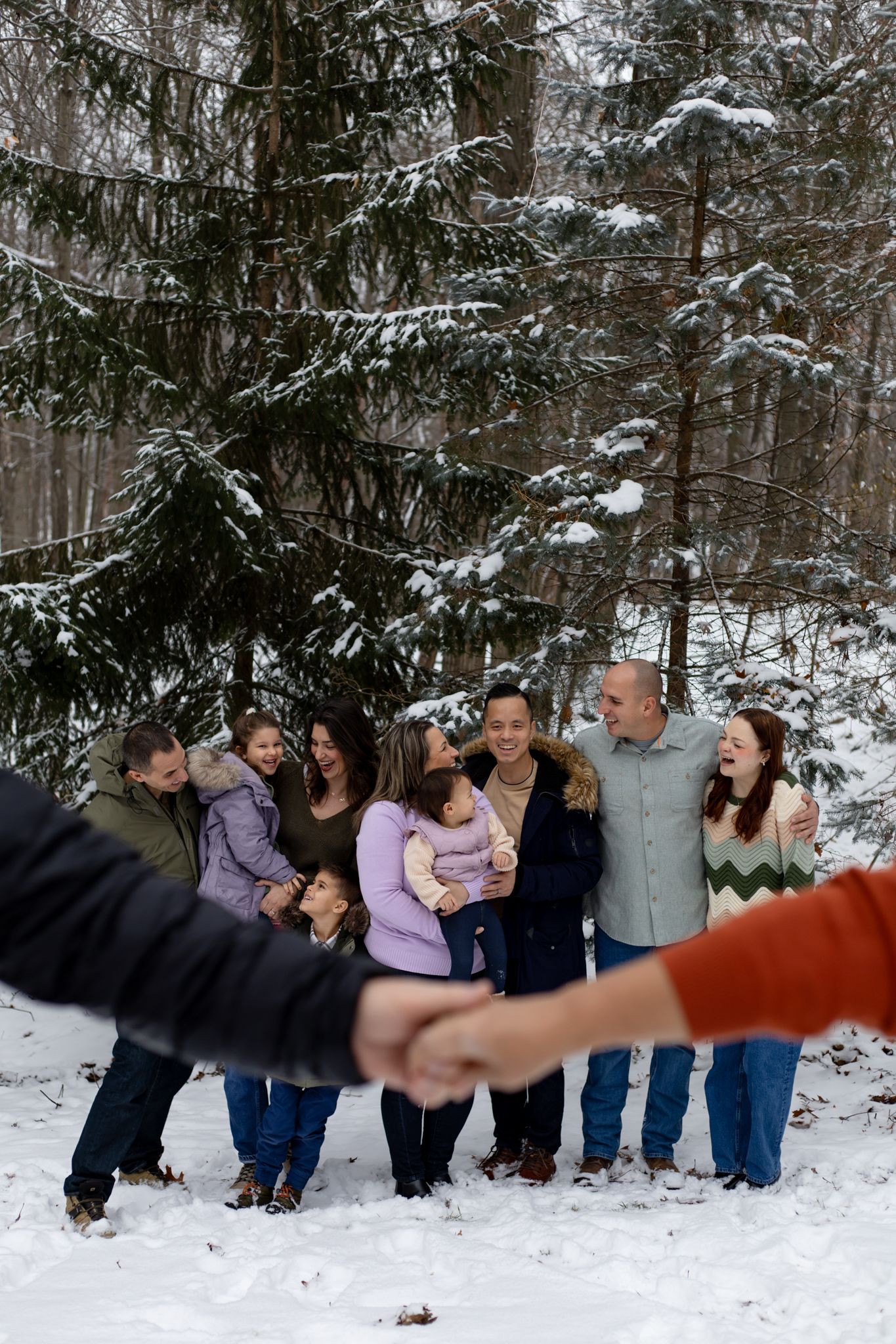 Group poses together in snowy winter forest setting.