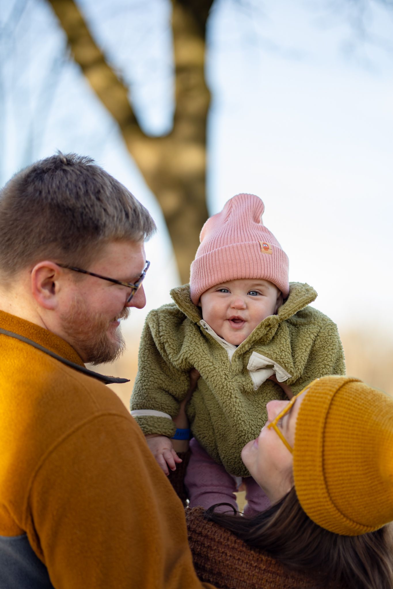 Candid family moments captured during a sunset photoshoot with warm autumn colors.