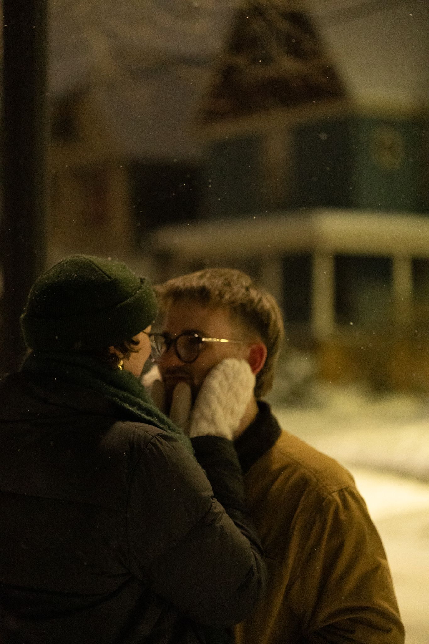 Two people share an intimate moment in the winter night.