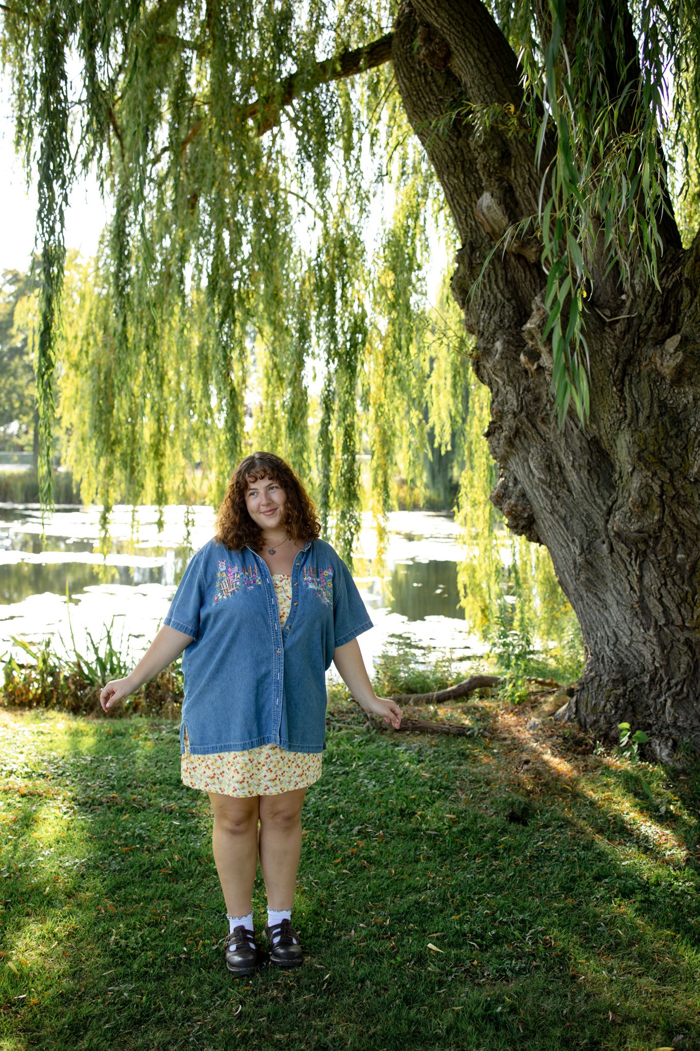 Scenic portraits under weeping willow trees near waterfront.