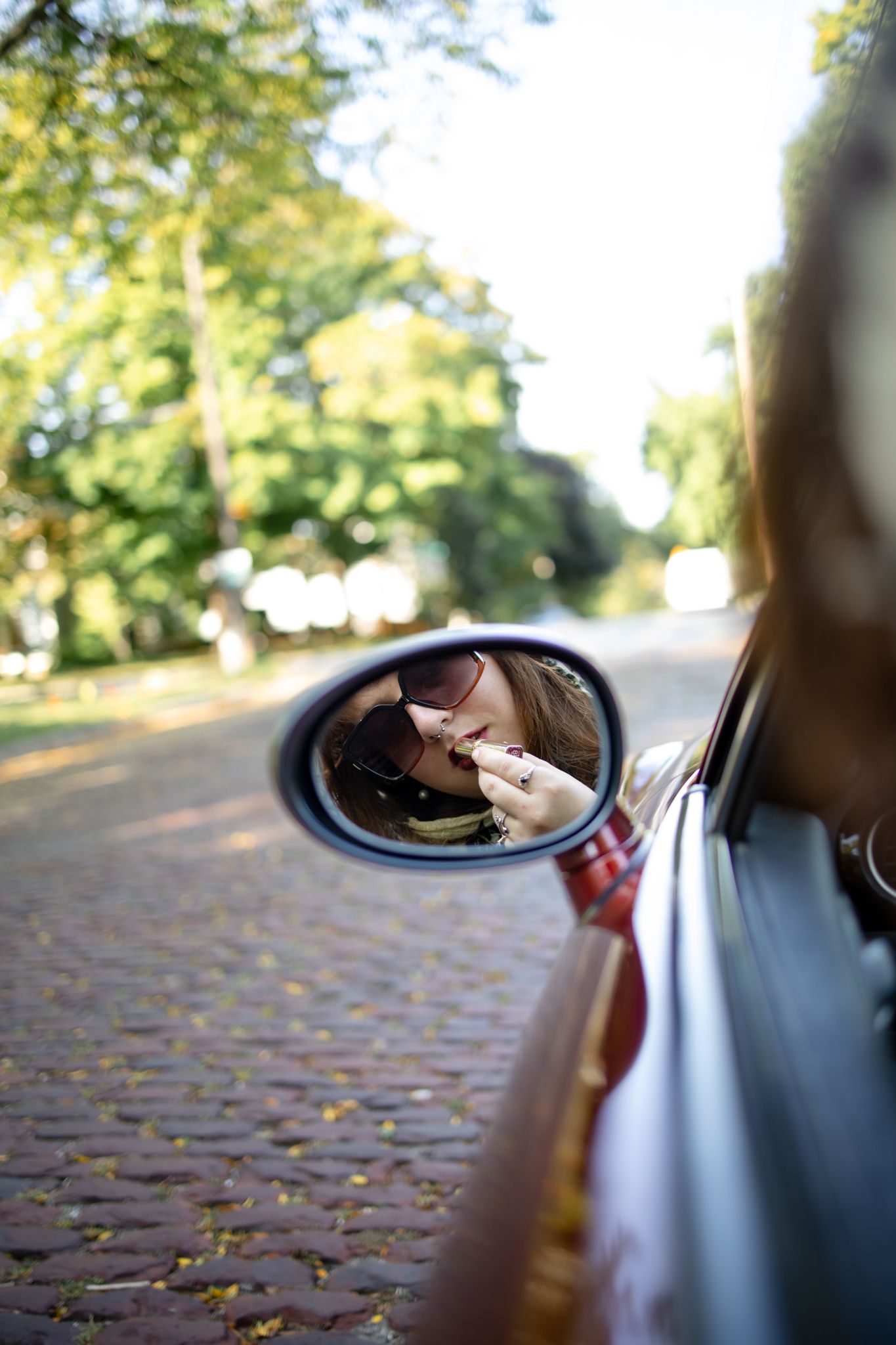 Artistic sequence focusing on car side mirror reflections outdoors.