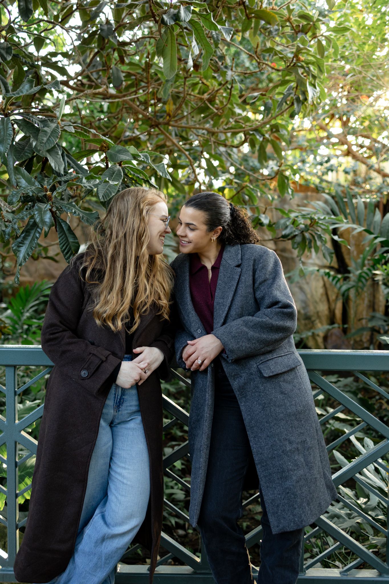 A romantic sequence of photos showing a couple sharing tender moments against a garden fence backdrop.