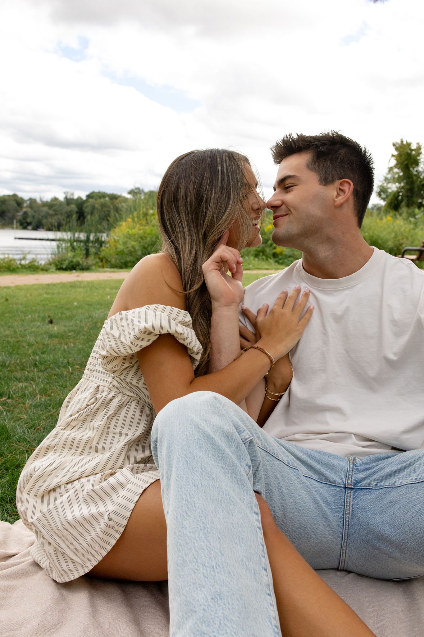 Intimate moments captured on a blanket during an outdoor summer photoshoot.