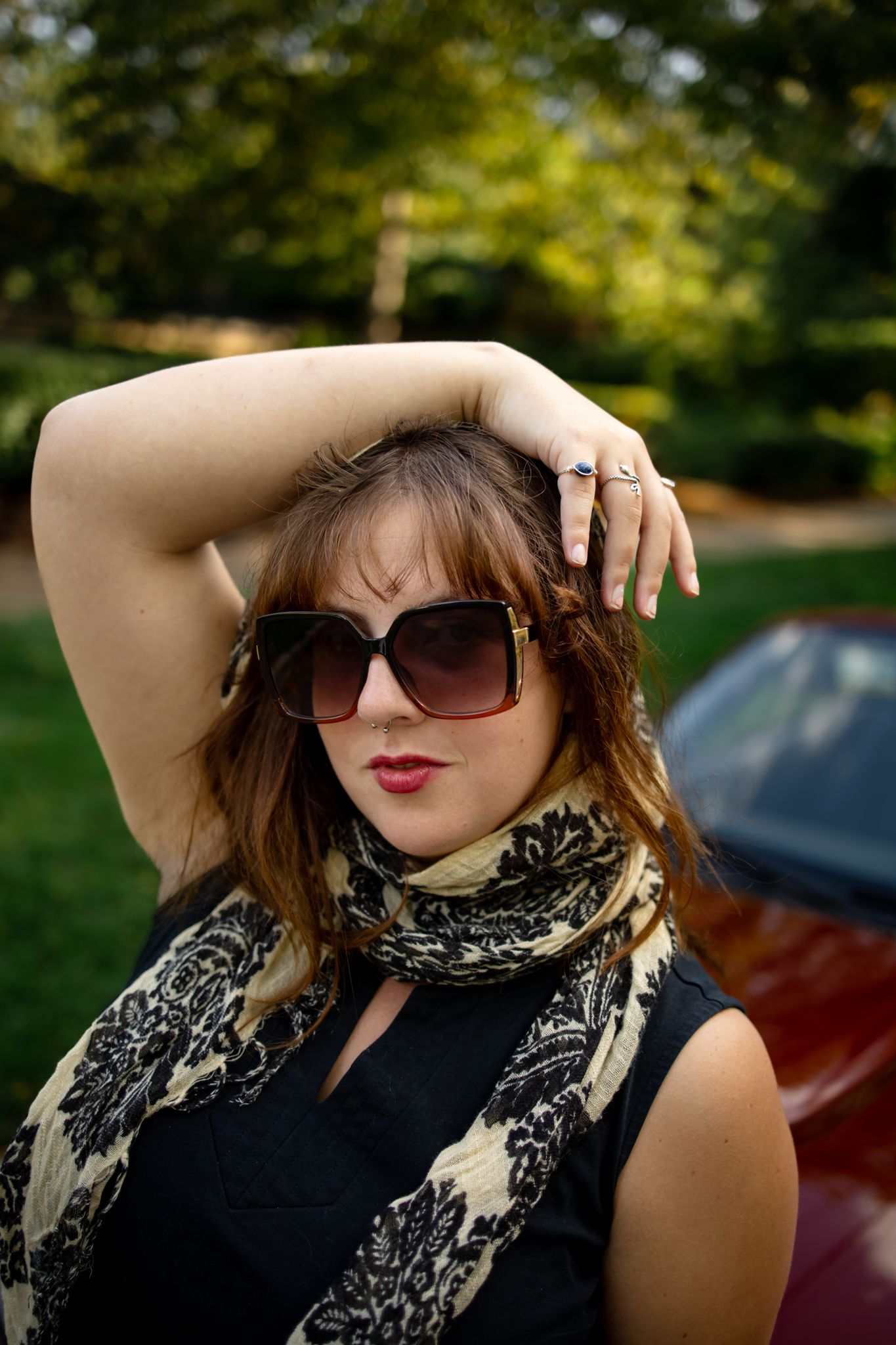 Stylish sunglasses and scarf accessory details in outdoor portrait sequence.