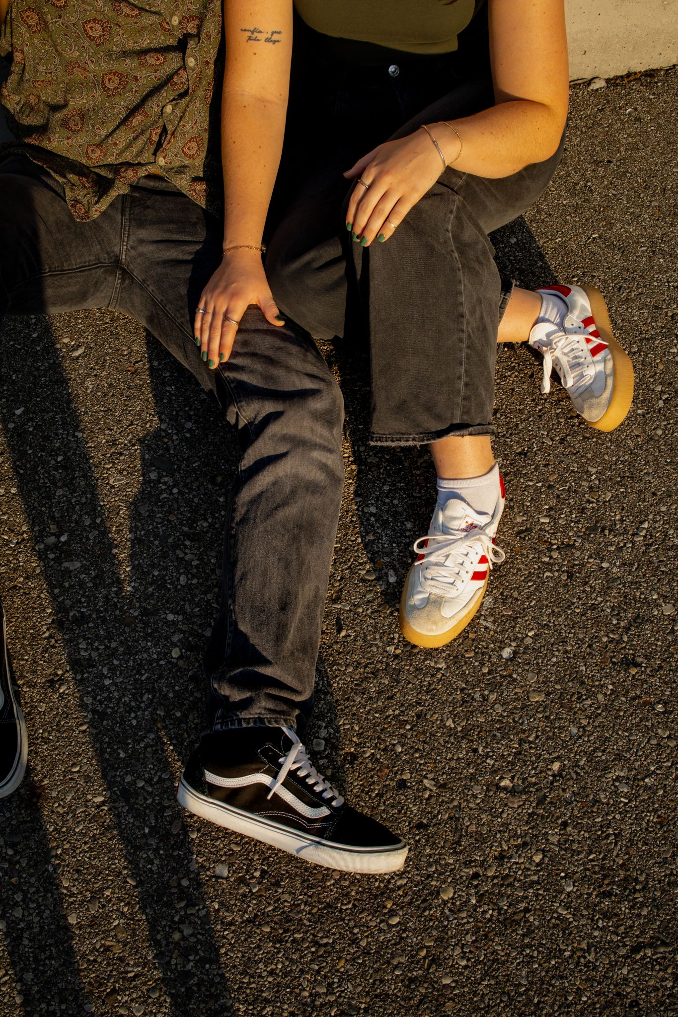 Close-up view of sneakers and shoes on asphalt ground in sequence.