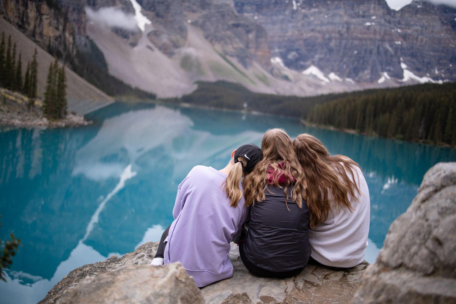 Snow-capped mountain peaks reflecting in a pristine alpine lake.