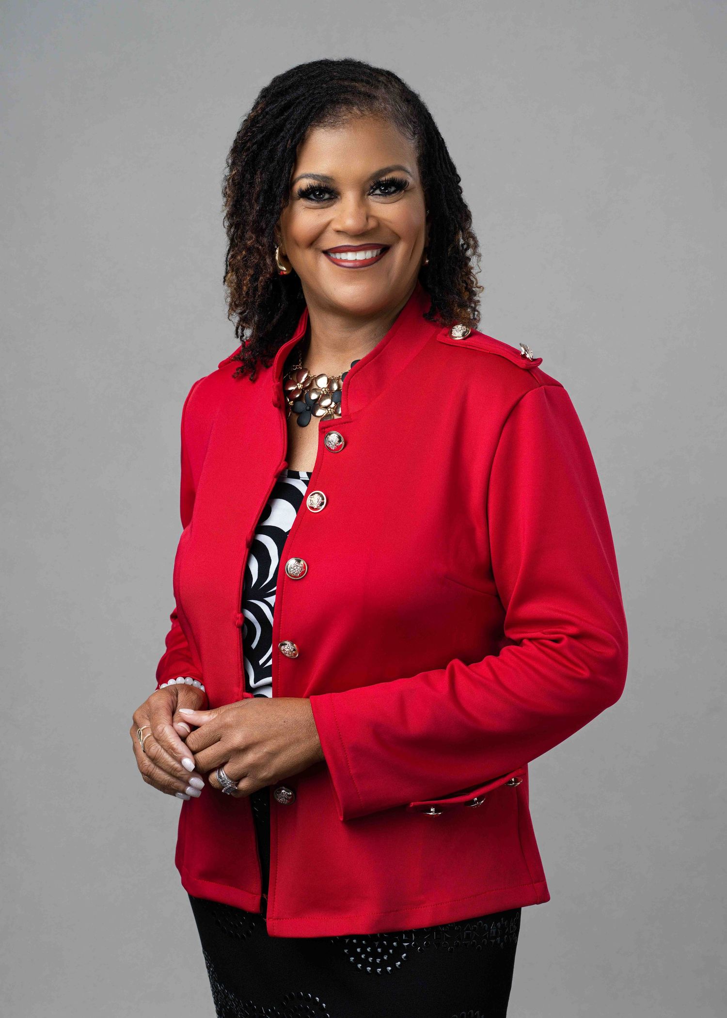 Close-up professional headshot of a woman with a warm expression, suitable for corporate or creative profiles.