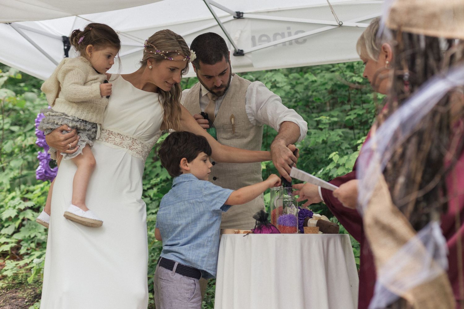 Les mariés et leurs enfants pratiquant une cérémonie familiale de mariage.