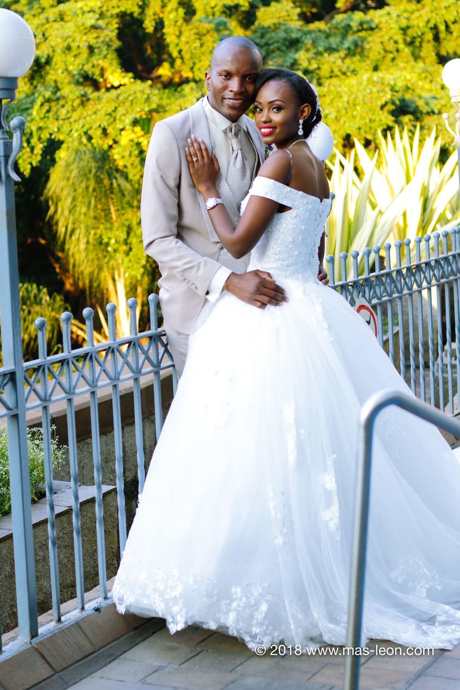 Husband and wife wedding couple portrait on hotel balcony