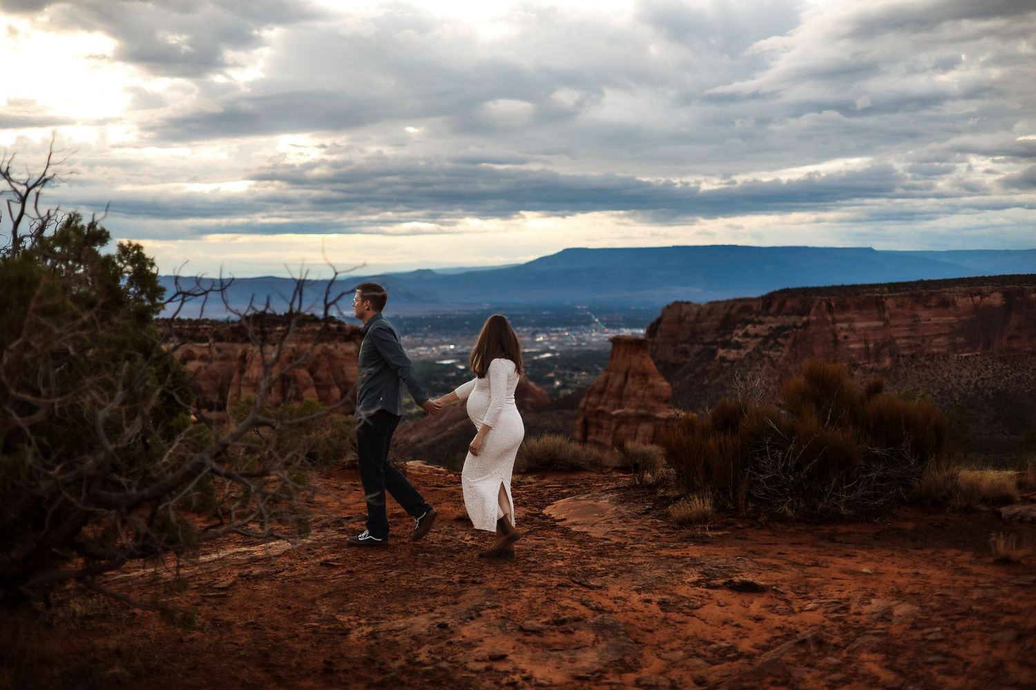 A dramatic series of panoramic photos showing red rock formations under cloudy skies at a scenic overlook.