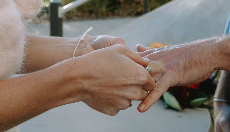 Close-up sequence of hands clasping together during an intimate moment.