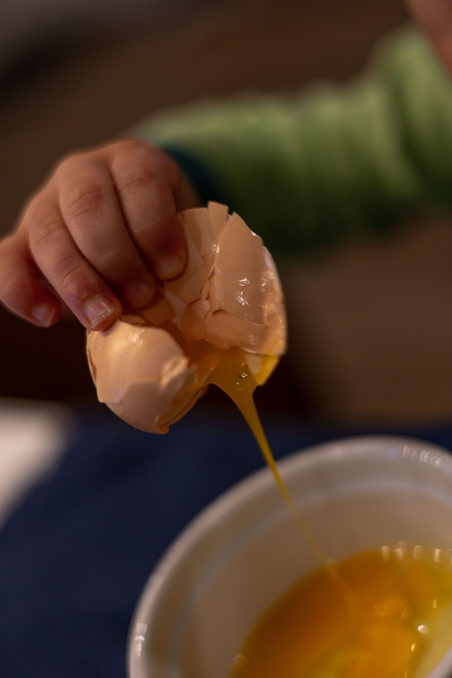 A sequence of images showing someone mixing ingredients in a metal bowl with measuring spoons and liquid being poured.