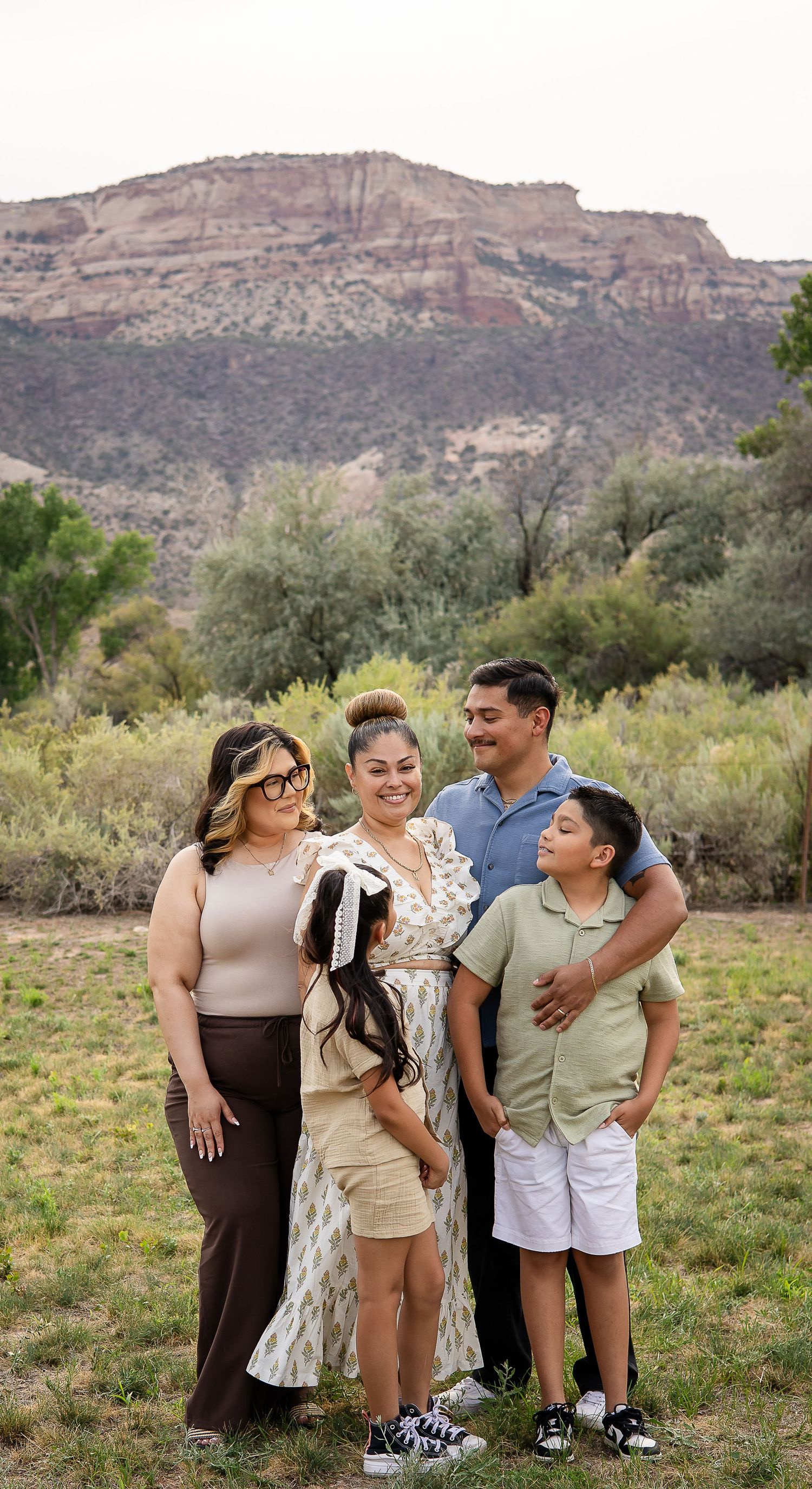 Family gathering in front of the Colorado National Monument for a family session in Grand Junction, Colorado.