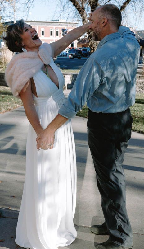 Sequence of dance moves between two people in white dress and blue attire on a paved path.