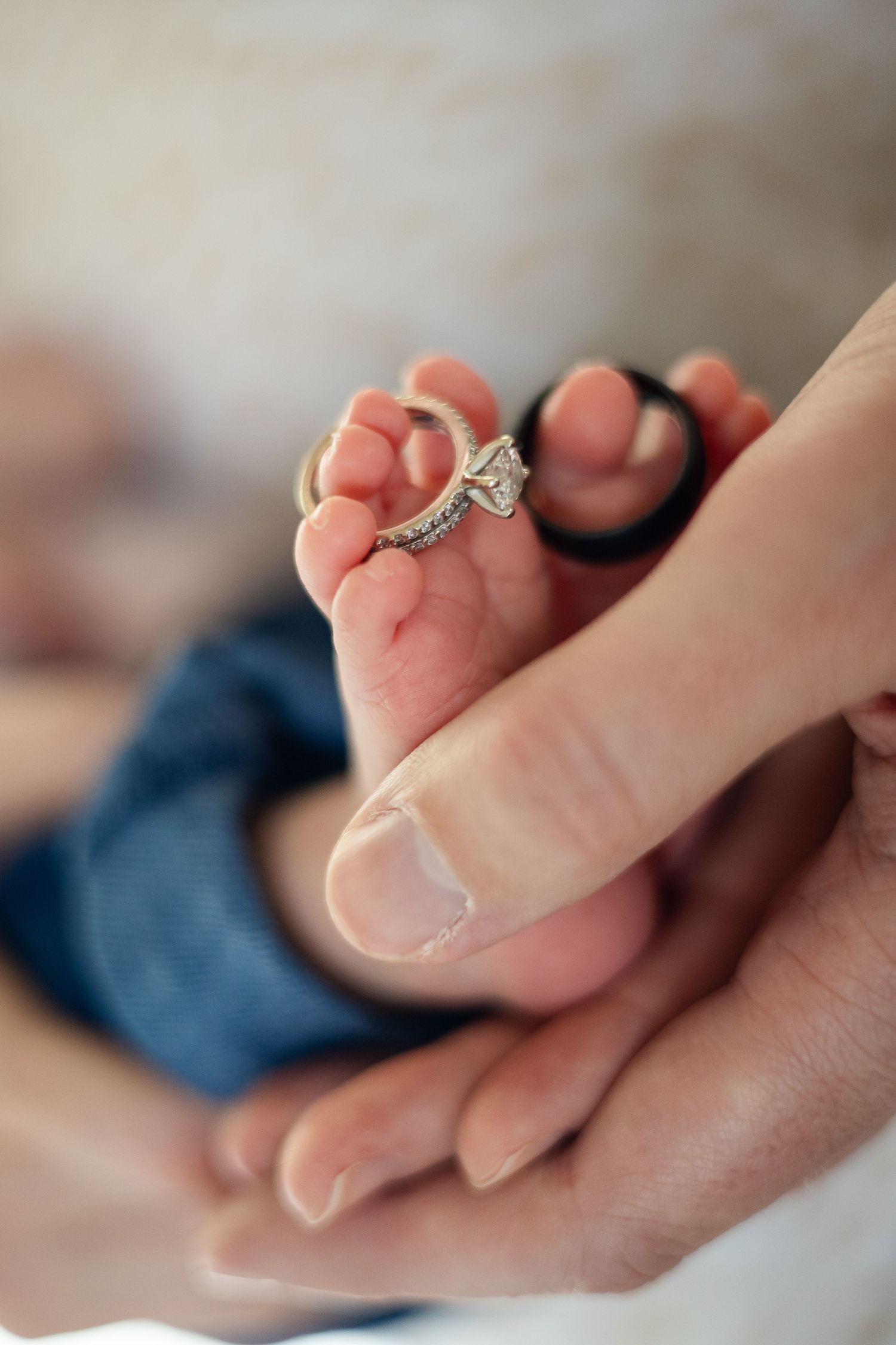 Close-up macro shots of hands holding a delicate diamond engagement ring against a soft blurred background.