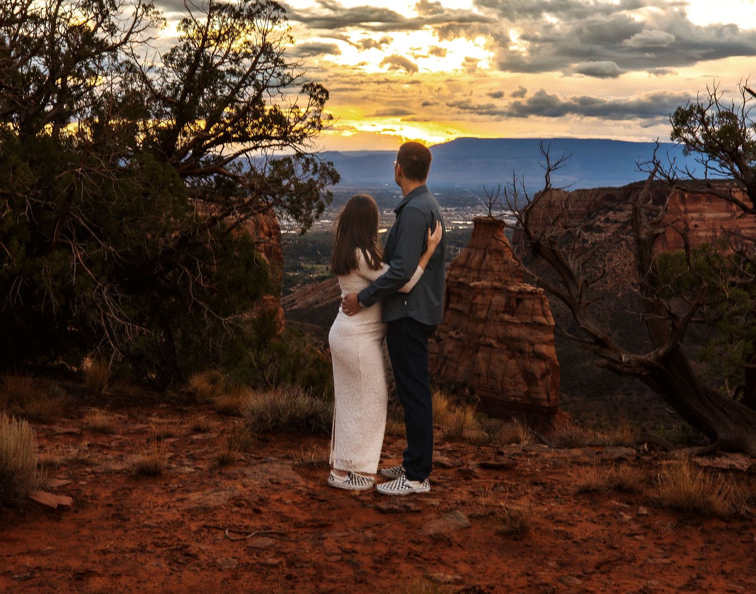 A romantic sunset proposal silhouette sequence captured against dramatic skies at a scenic desert overlook.