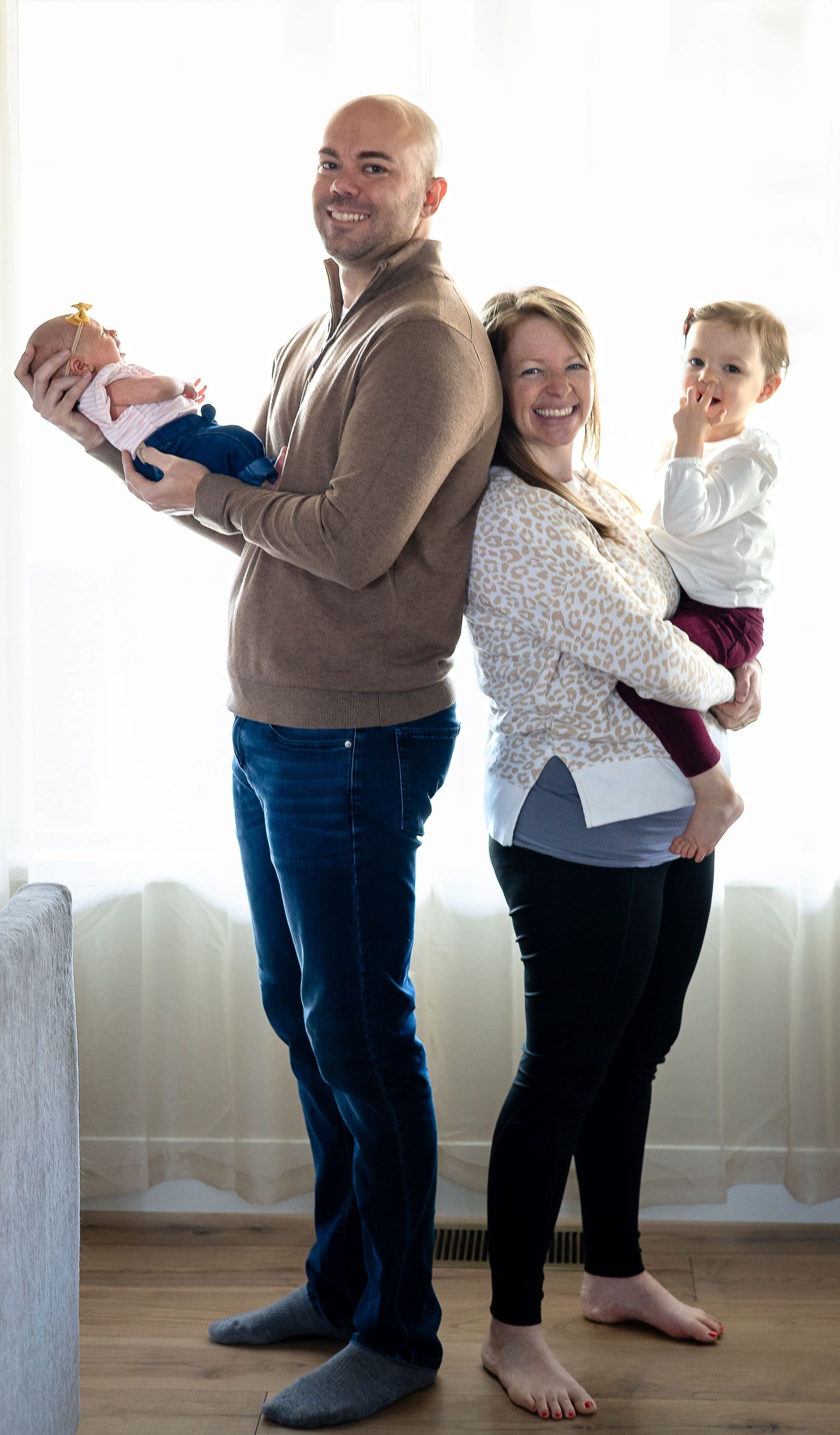 A couple dances together in a bright room, creating a sequence of playful dance moves.