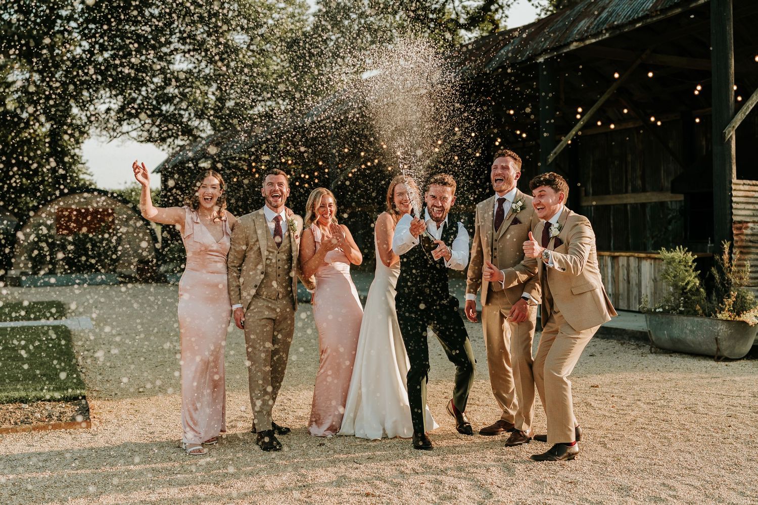 Champagne Spray moment captured at Hampshire wedding venue, Silchester Farm.