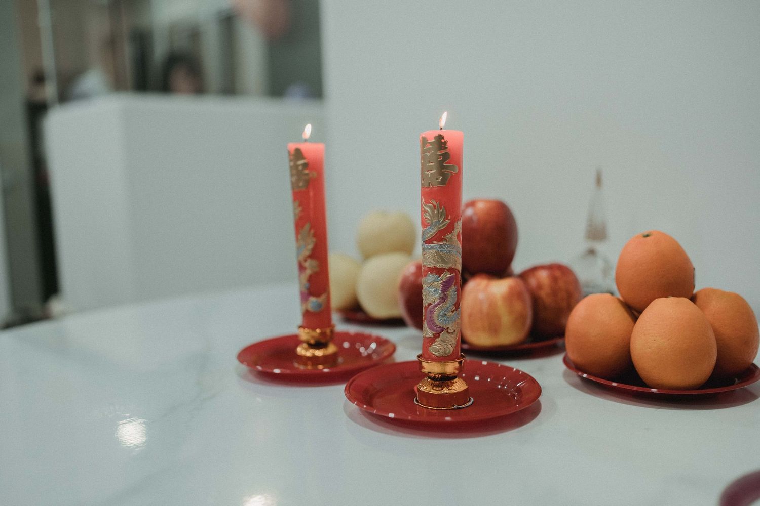 Dragon and phoenix candles with oranges and apples, traditional Chinese wedding gifts at a Singapore home