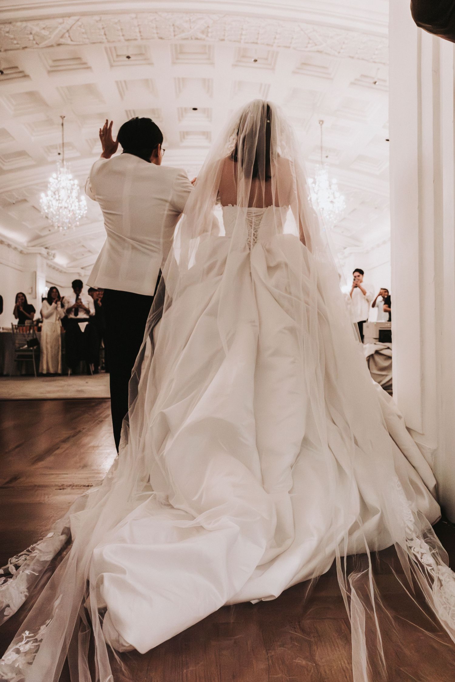 Bride and groom walking into their wedding banquet ballroom in Singapore