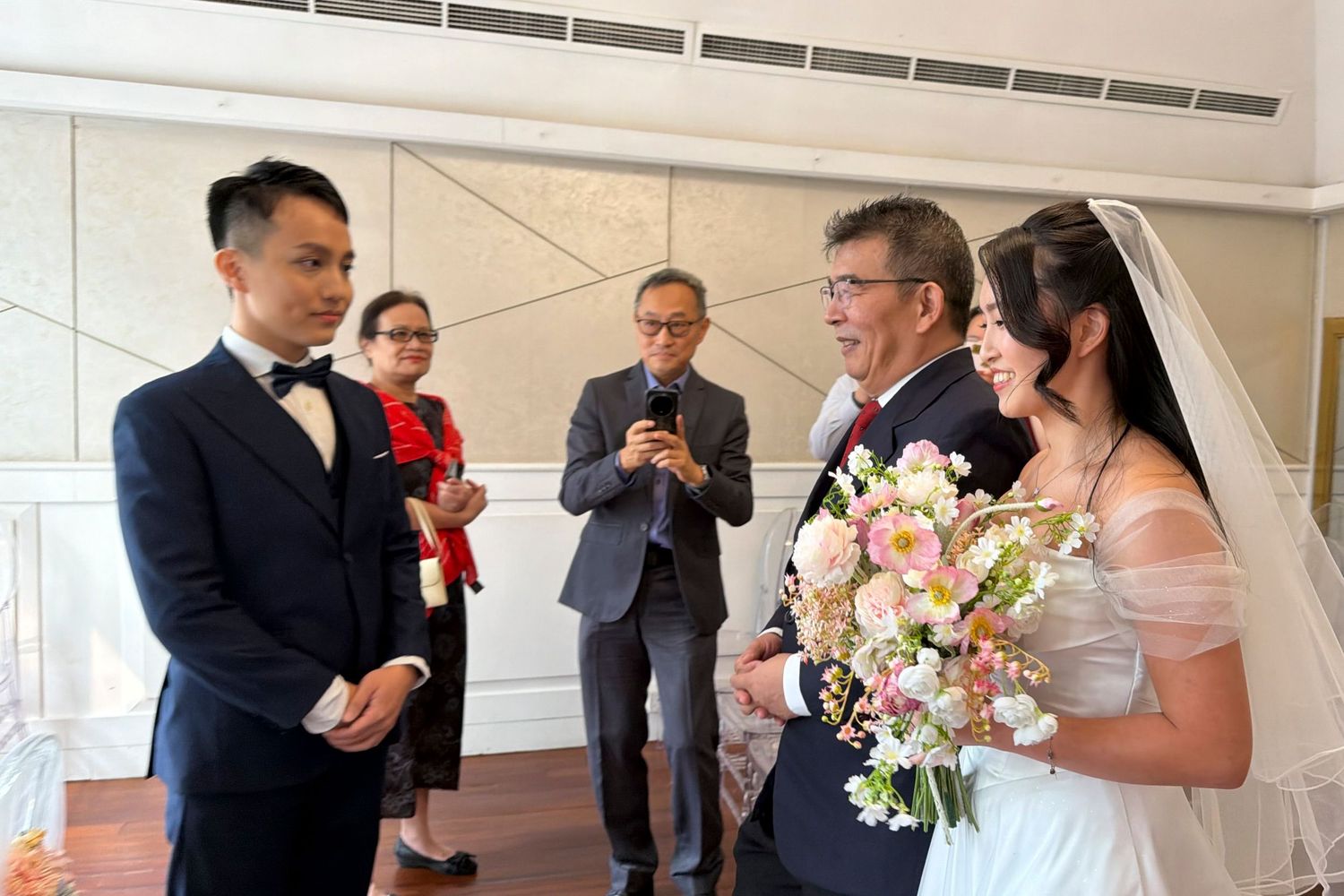 Father walking the bride down the aisle to the groom at a Singapore wedding ceremony, professional wedding photography