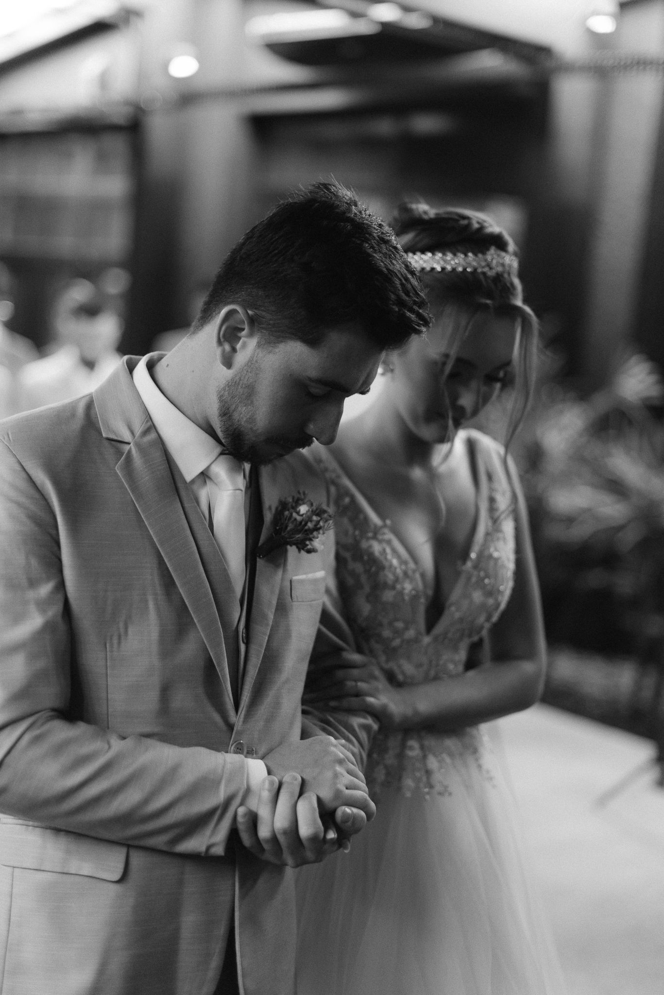 Intimate black and white portrait of a couple sharing a tender moment at their wedding celebration.