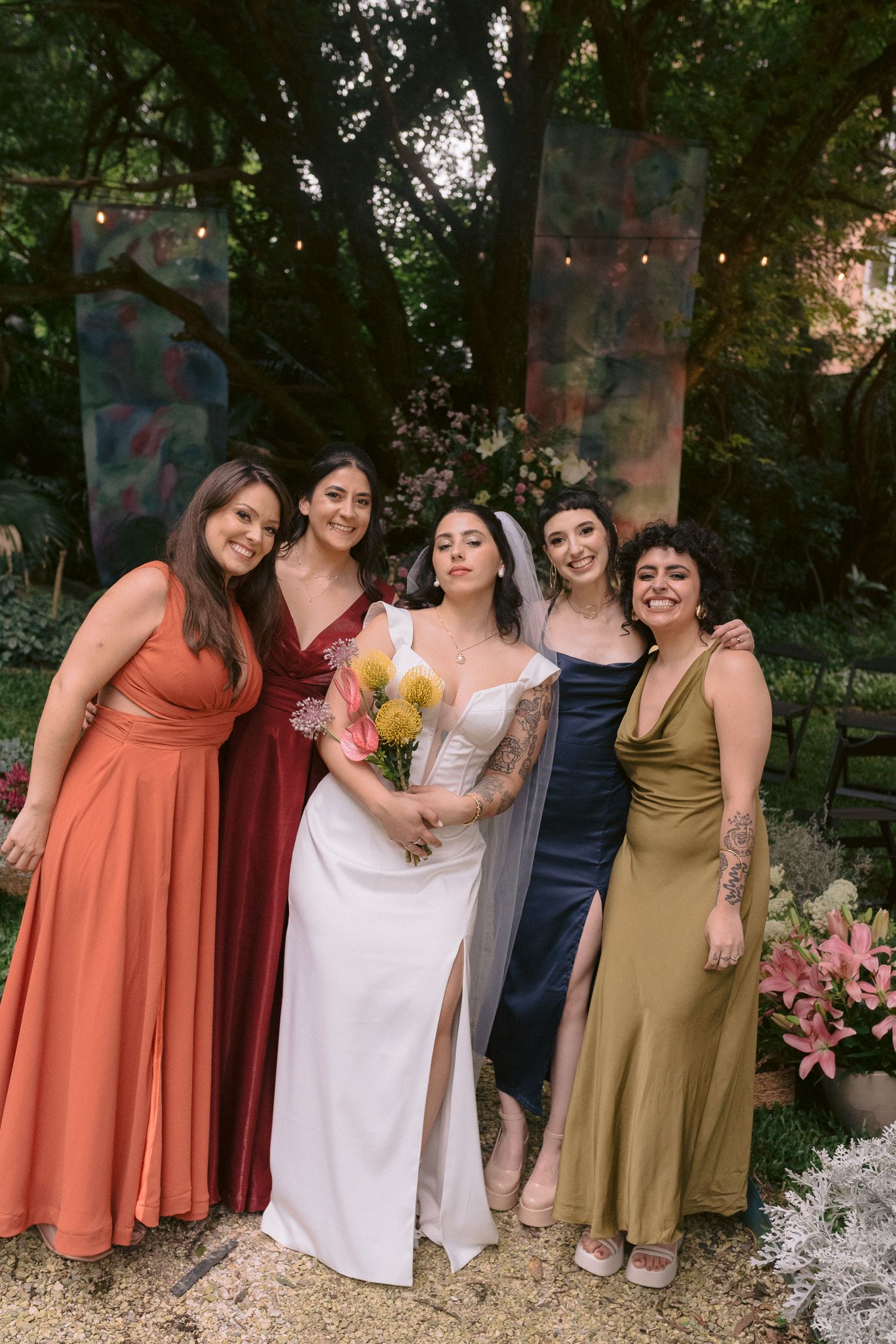 Candid group shots of a wedding party laughing and celebrating in a garden.