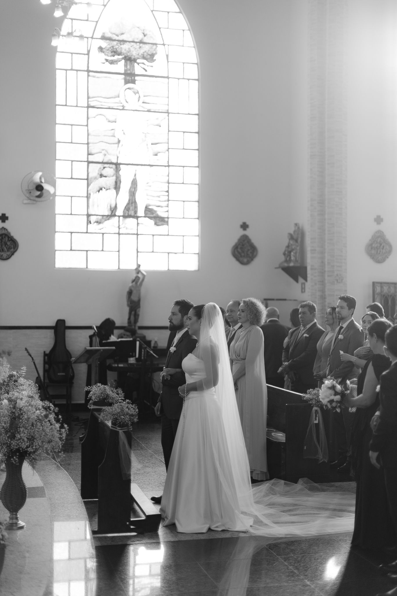 Black and white photos show a beautiful church wedding ceremony with traditional bridal procession down the aisle.