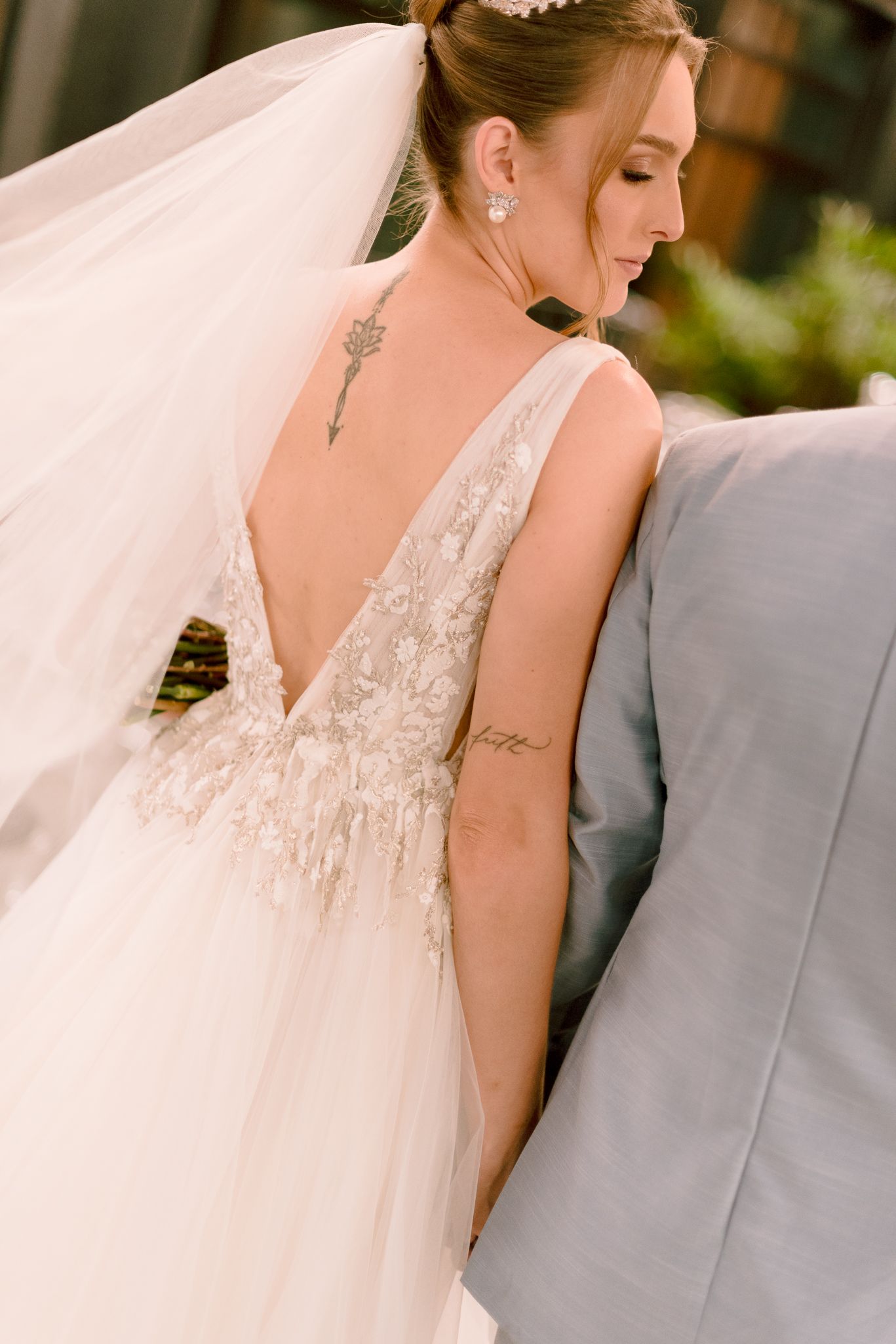 Close-up detail shots of a bride in a lace wedding dress with a flowing veil.