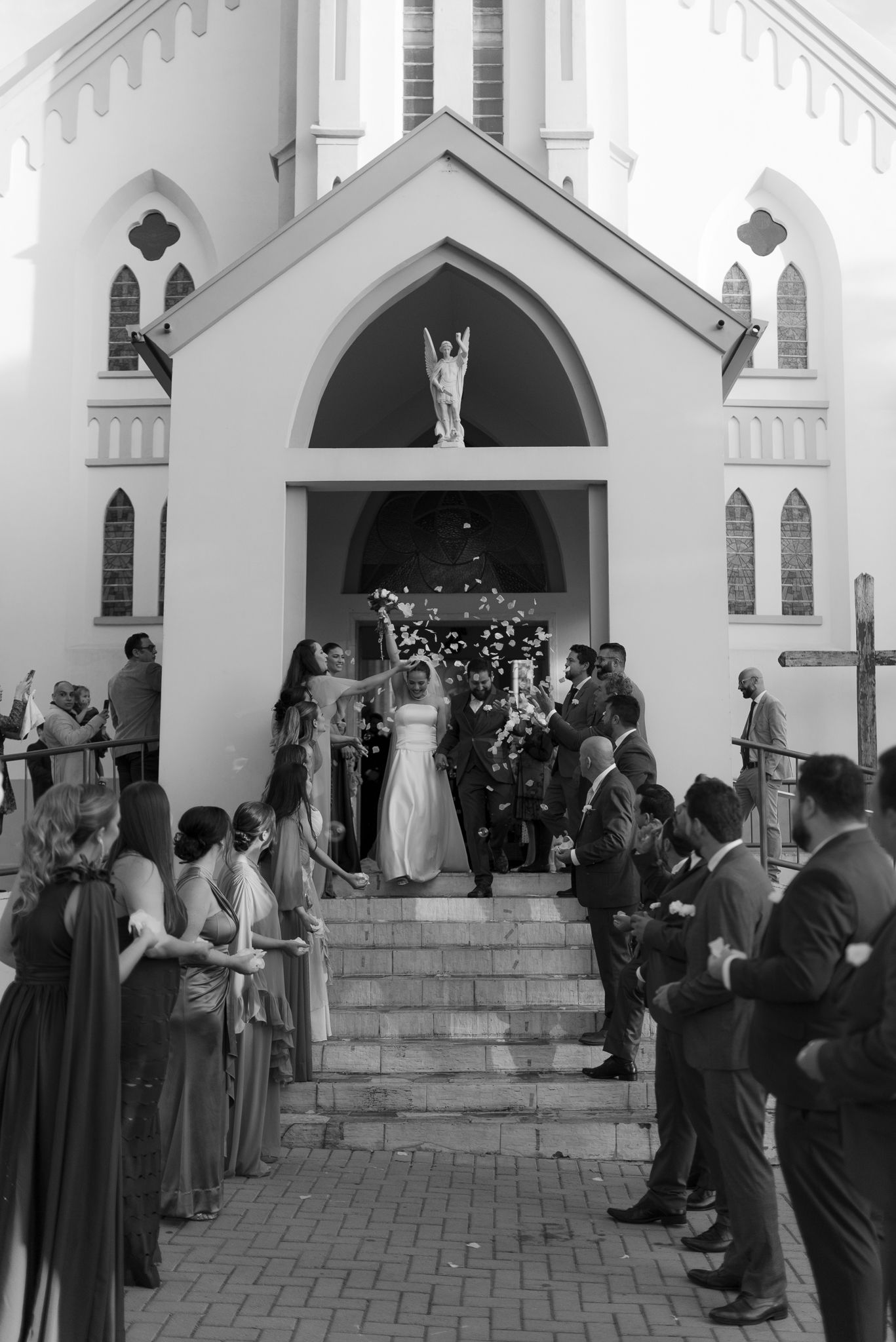 Wedding ceremony in progress at a beautiful white church with gothic architecture, shown in sequence from multiple angles.