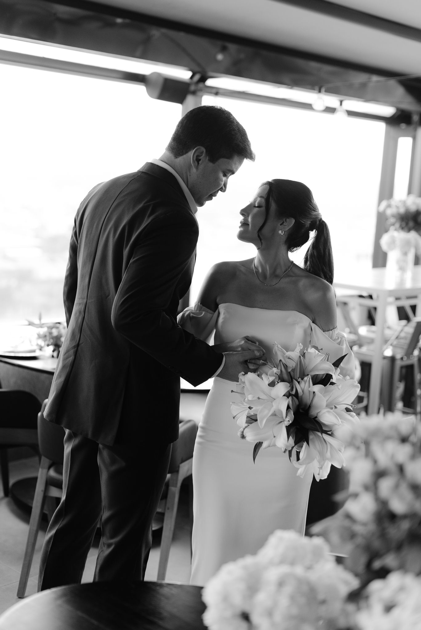 Black and white candid shots of a wedding couple during their reception.