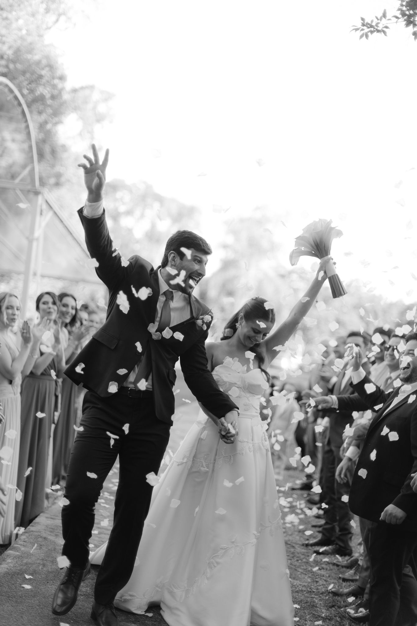 Wedding party celebrates with colorful smoke bombs creating a joyful atmosphere in an outdoor celebration.